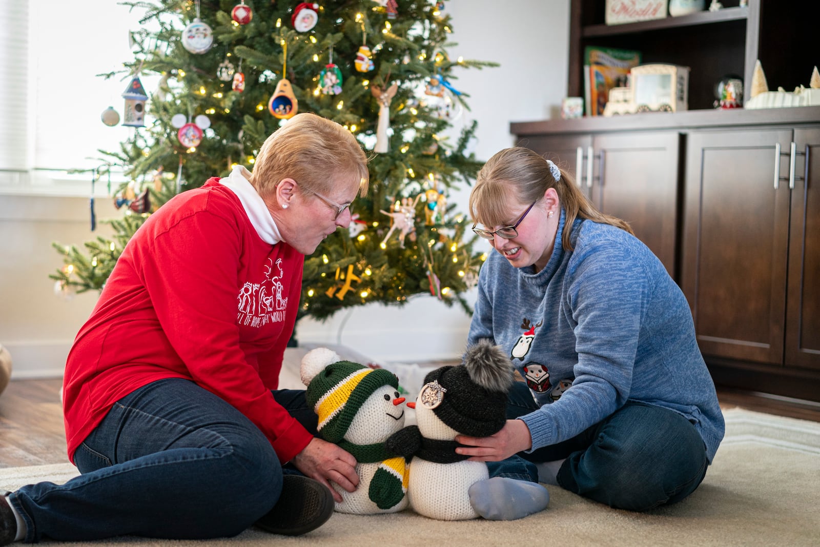 Kathleen Krueger plays with her daughter, Megan, 28, at their home in Racine, Wis., Friday, Dec. 20, 2024. (AP Photo/Andy Manis)