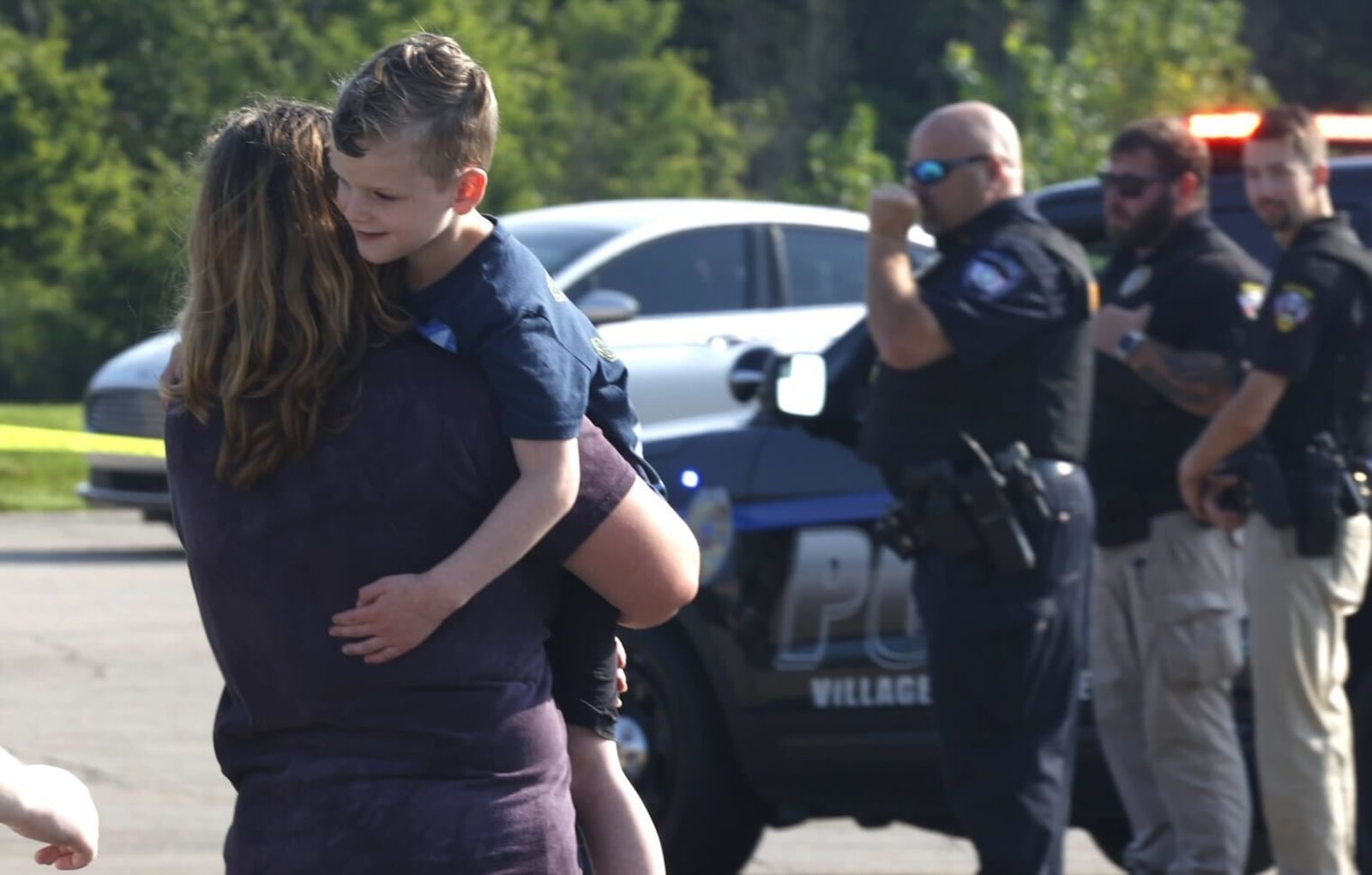 At least one person was killed after a Northwestern school bus was involved in a crash on Route 41 in German Twp. Tuesday, Aug. 22, 2023. Parents came to the scene to reunite with their children. BILL LACKEY/STAFF