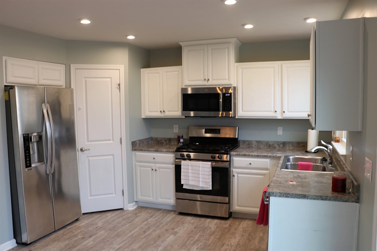 The U-shaped kitchen has a window above the double sink and a corner pantry closet.