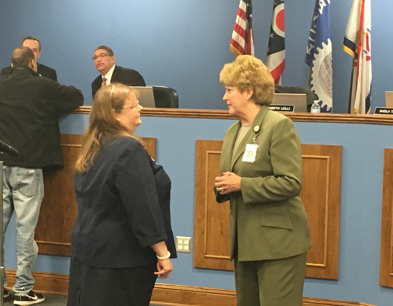 Dayton Public Schools Superintendent Elizabeth Lolli (right) talks to DPS Human Resources Director Judith Spurlock at a school board meeting. Spurlock will leave her current role to become a principal again in fall 2019, as the district is also reconfiguring its Human Resources department. JEREMY P. KELLEY / STAFF