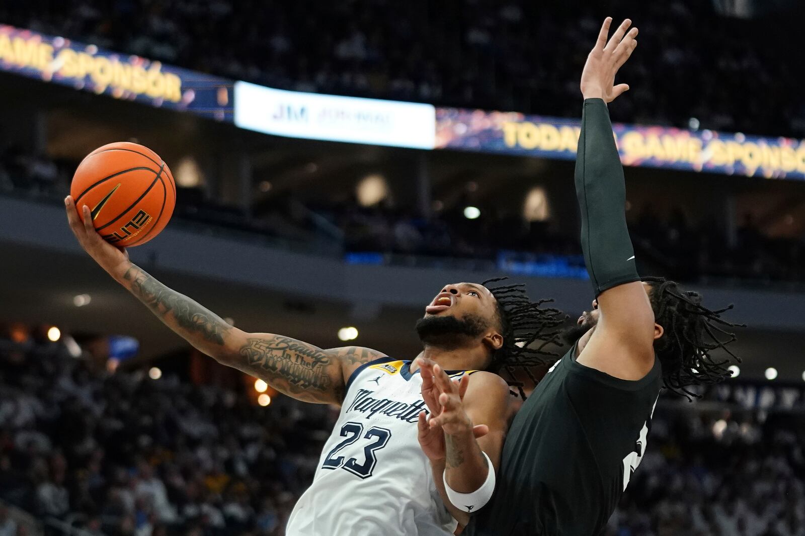 Marquette's David Joplin (23) shoots over Xavier's Jerome Hunter (2) during the first half of an NCAA college basketball game Saturday, Jan. 18, 2025, in Milwaukee. (AP Photo/Aaron Gash)