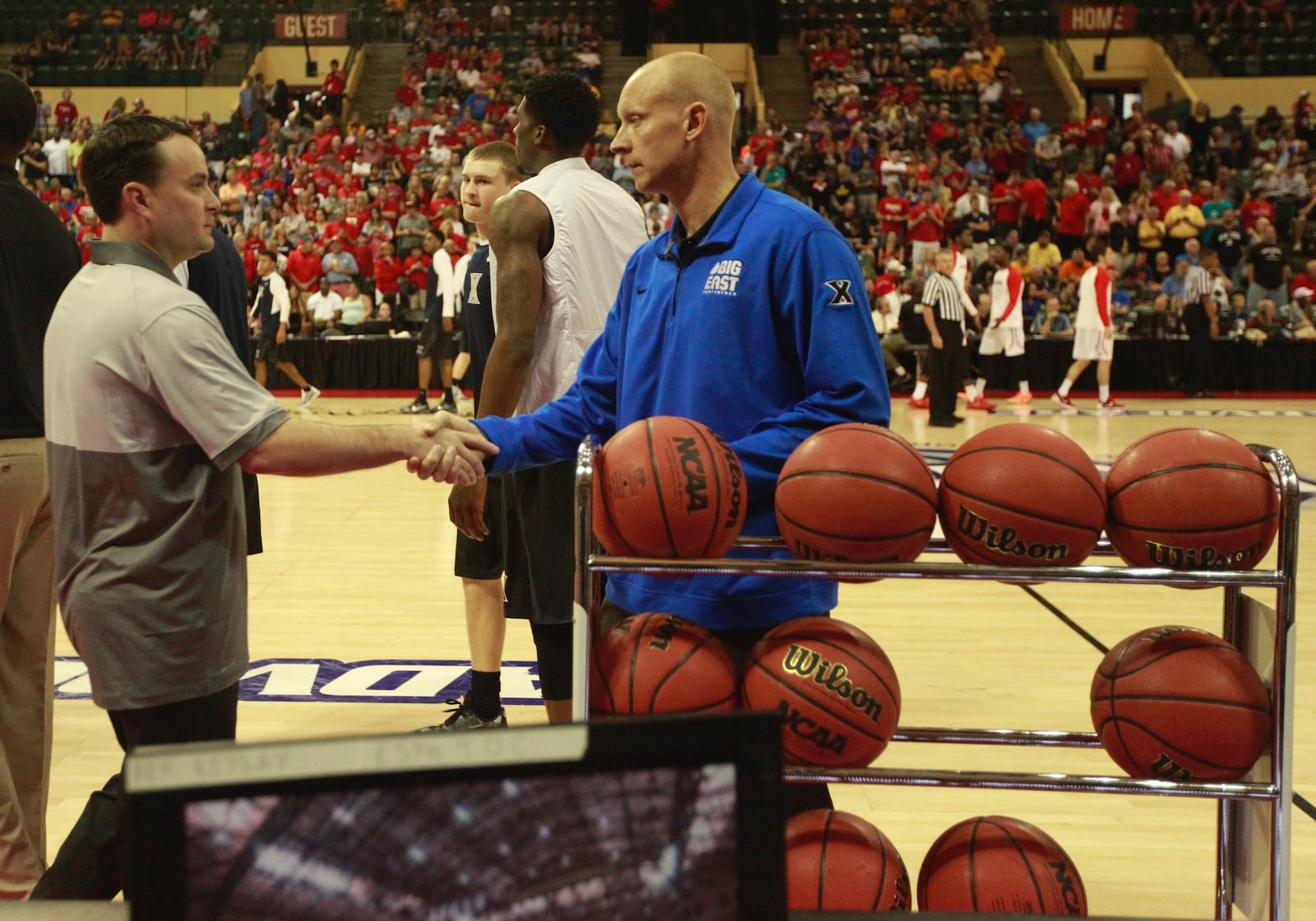 Dayton coach Archie Miller, left, shakes hands with Xavier coach Chris Mack before the championship game of the AdvoCare Invitational on Sunday, Nov. 29, 2015, at the HP Field House in Orlando, Fla. David Jablonski/Staff