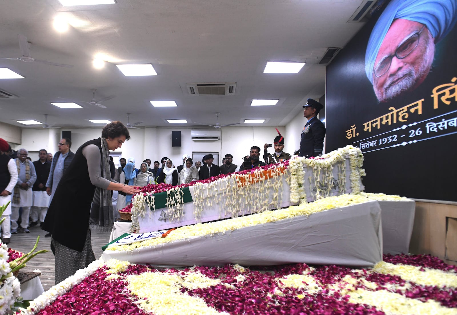 Congress Party leader Priyanka Gandhi Vadra touches the casket of former Indian Prime Minister Manmohan Singh to pay her tributes at the party headquarters in New Delhi, India, Saturday, Dec. 28, 2024. (AP Photo)