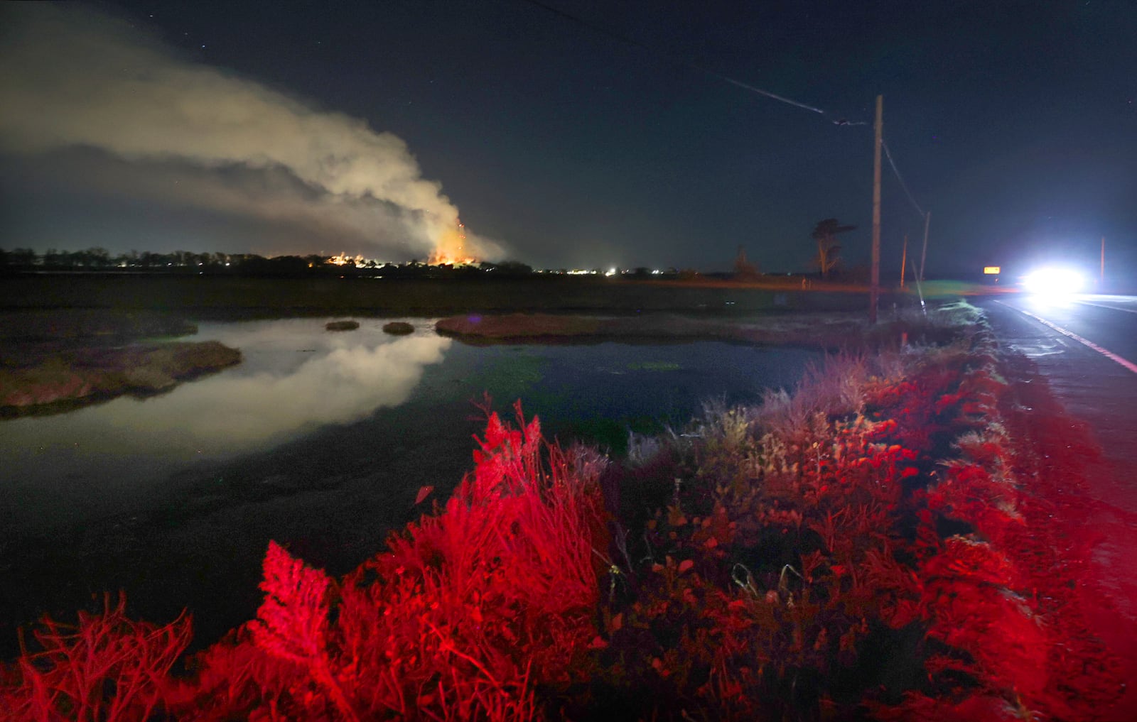 Flames and smoke from a fire fill the sky at the Moss Landing Power Plant Thursday Jan. 16, 2025 in Moss Landing, Calif. (Shmuel Thaler /The Santa Cruz Sentinel via AP)