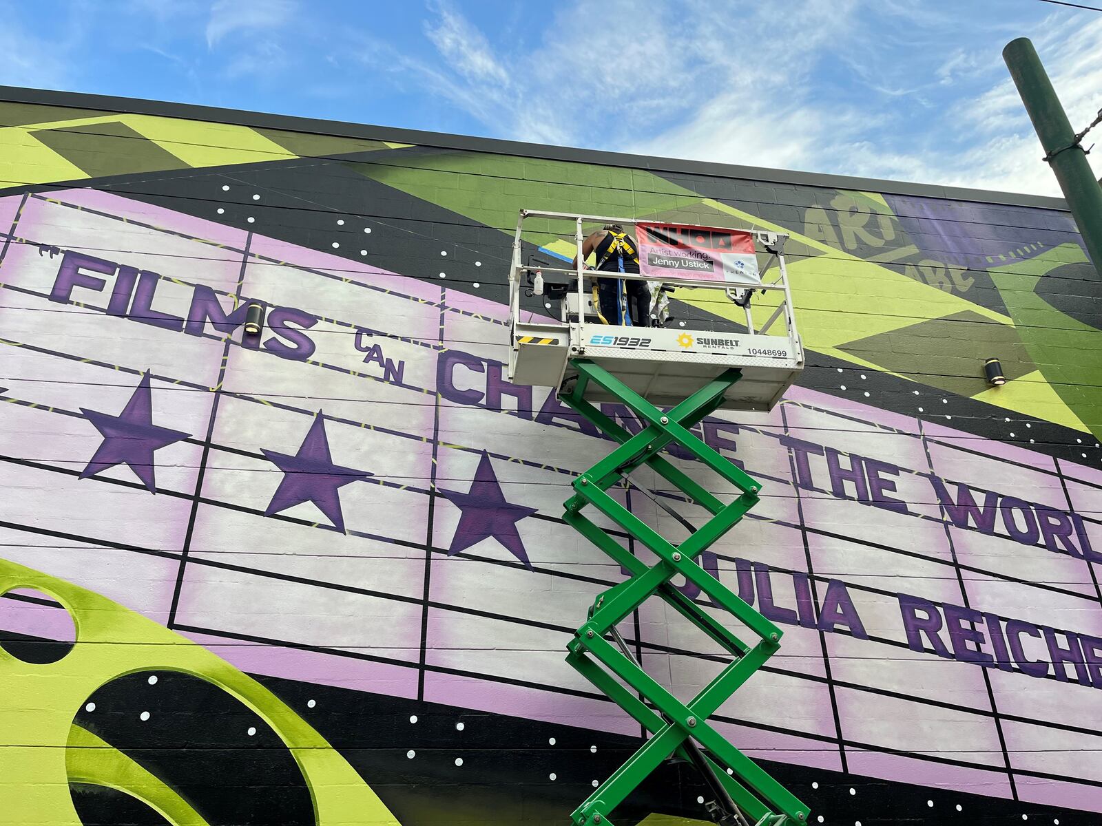 The Neon, an art house cinema in downtown Dayton, has a colorful new exterior. The mural pays tribute to Julia Reichert, a local, Oscar-winning documentarian. CORNELIUS FROLIK / STAFF