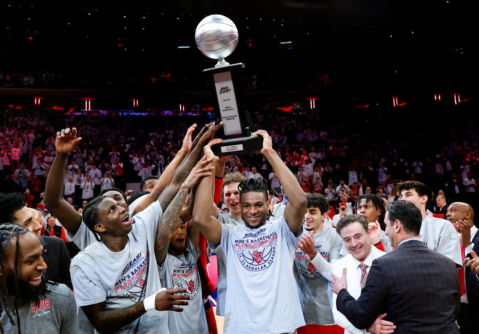 St. John's forward Zuby Ejiofor, center, celebrates with teammates after winning the Big East conference regular season title after they defeated Seton Hall in an NCAA college basketball game, Saturday, March 1, 2025, in New York. (AP Photo/Noah K. Murray)