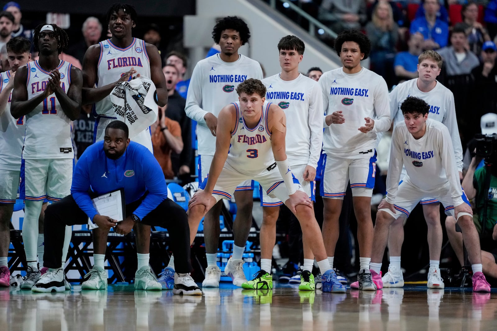 Florida teammates watch from the bench during the second half in the second round of the NCAA college basketball tournament against Connecticut, Sunday, March 23, 2025, in Raleigh, N.C. (AP Photo/Stephanie Scarbrough)