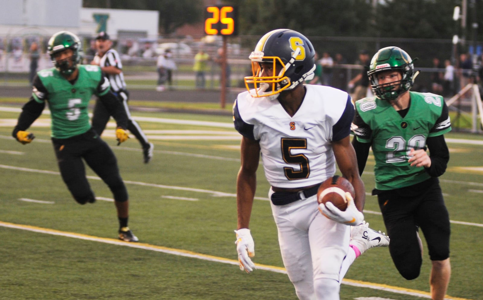 Springfield’s Larry Stephens is pursued by Andrew Knick (right) of Northmont. MARC PENDLETON / STAFF