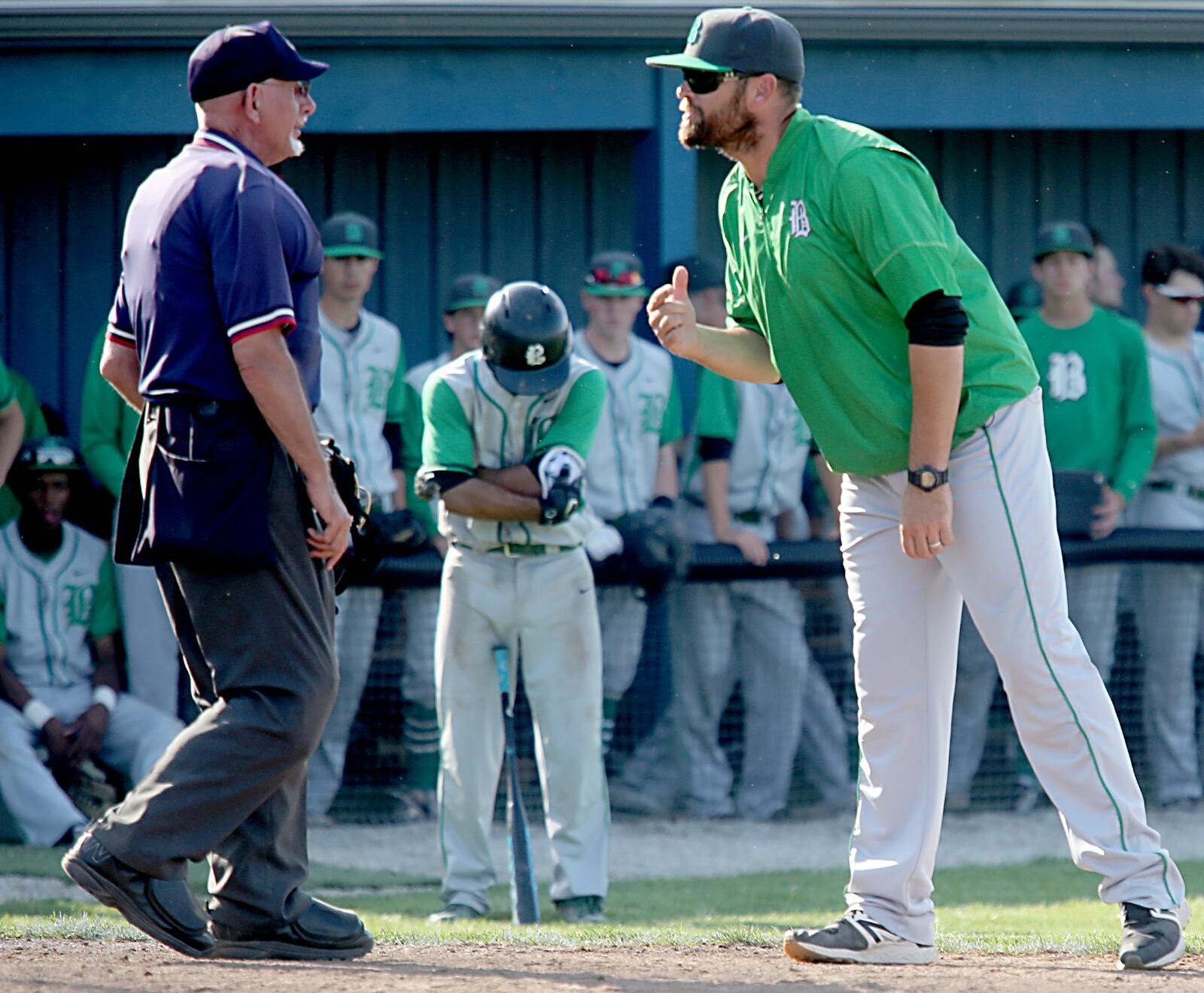 Badin baseball coach Brion Treadway discusses a call with the home-place umpire during a Division II sectional final against Chaminade Julienne at Miamisburg on May 18, 2017. JOURNAL-NEWS FILE PHOTO