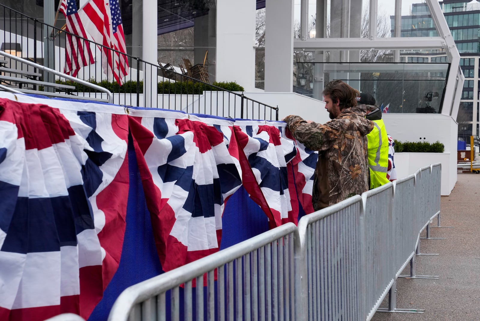 Work continues near the presidential reviewing stand on Pennsylvania Avenue outside the White House, Friday, Jan. 17, 2025, in Washington, ahead of President-elect Donald Trump's inauguration. (AP Photo/Jon Elswick)