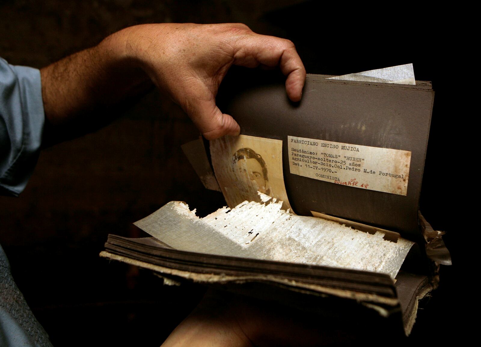 FILE - Paraguayan Senator Luis Alberto Wagner holds documents found in a recently discovered basement at the Interior Ministry headquarters in Asuncion, Paraguay, Oct. 31, 2008. (AP Photo/Jorge Saenz, File)