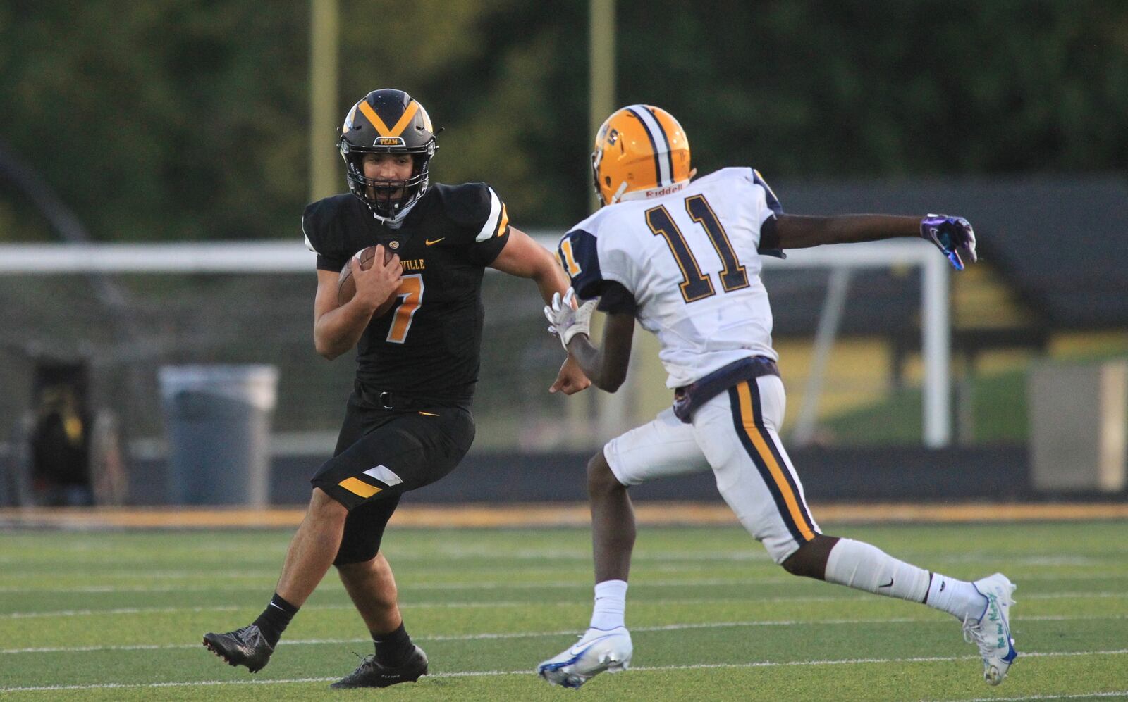 Centerville quarterback Chase Harrison tries to avoid Springfield's Tyshawn Walker on Friday, Sept. 4, 2020, at Centerville. David Jablonski/Staff