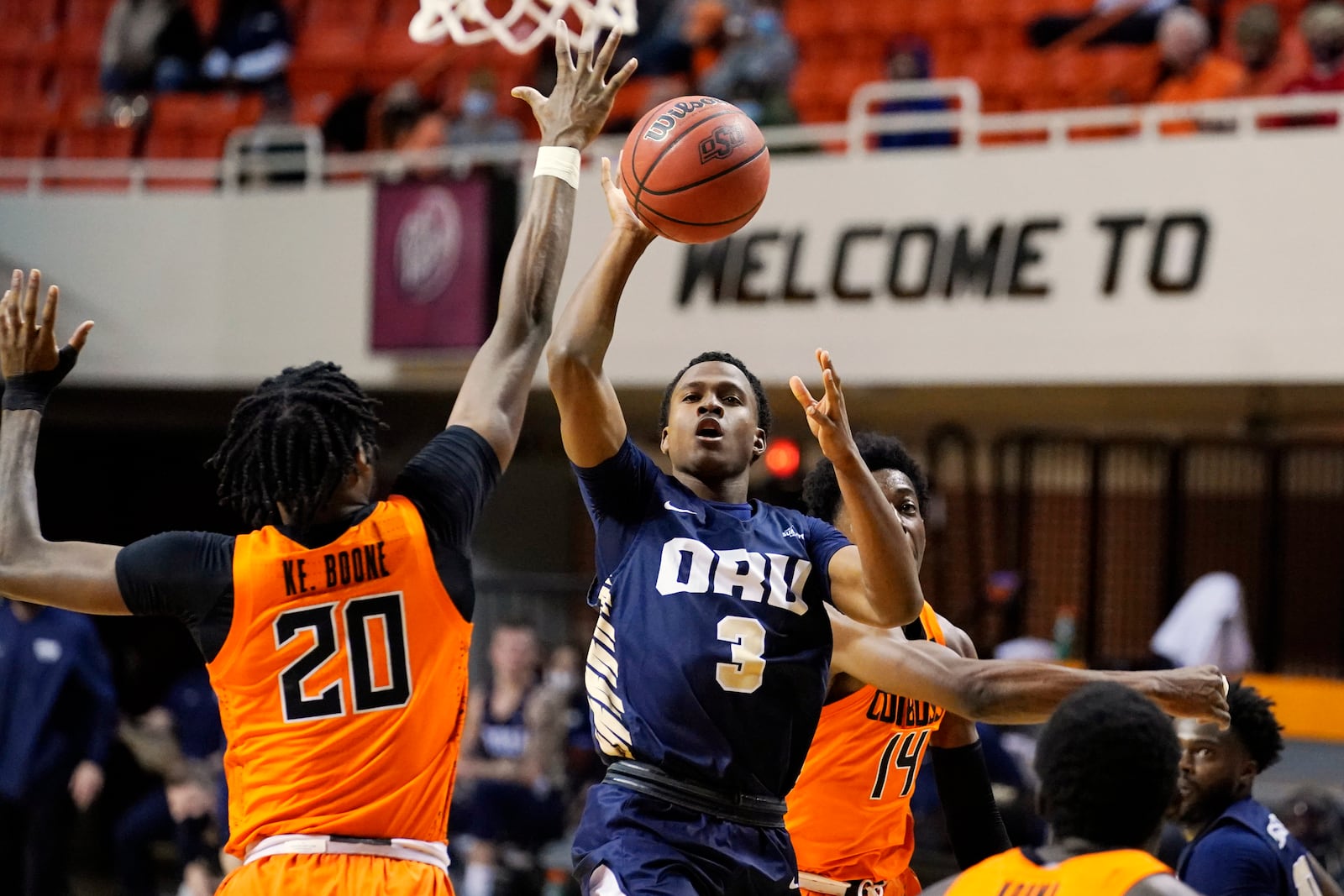 Oral Roberts guard Max Abmas (3) shoots between Oklahoma State guard Keylan Boone (20) and guard Bryce Williams (14) during the first half of an NCAA college basketball game Tuesday, Dec. 8, 2020, in Stillwater, Okla. (AP Photo/Sue Ogrocki)