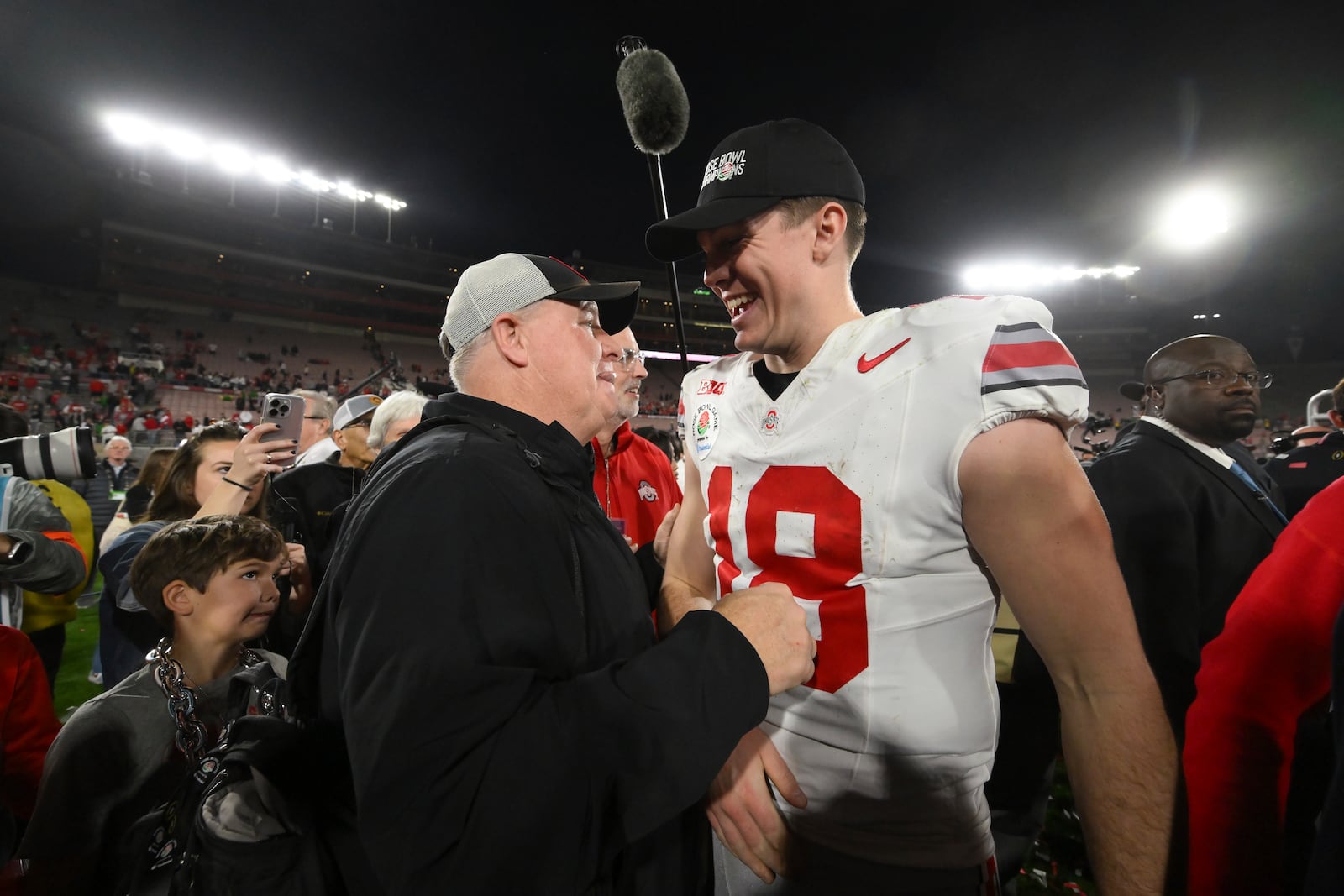 Ohio State offensive coordinator Chip Kelly, left, celebrates with quarterback Will Howard (18) after the quarterfinals of the Rose Bowl College Football Playoff against Oregon, Wednesday, Jan. 1, 2025, in Pasadena, Calif. (AP Photo/Kyusung Gong)