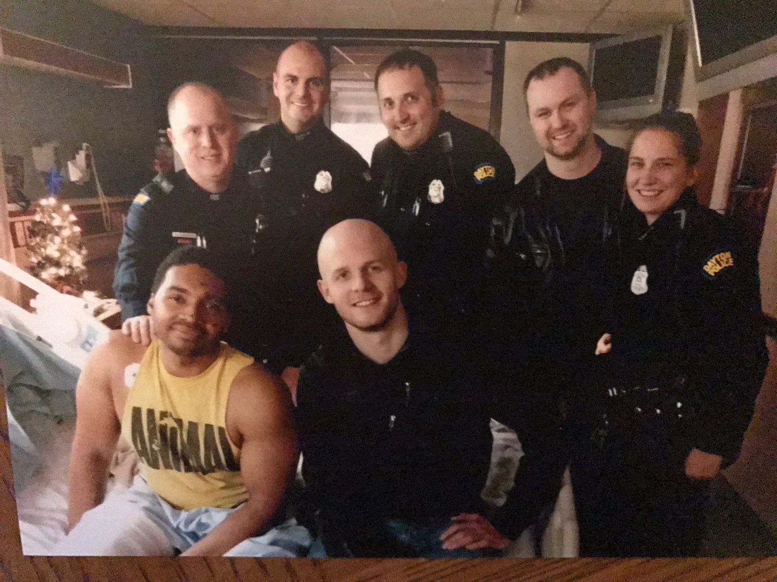 Dayton police officer Byron Branch with the other officers who aided him when he was hit by a sliding car in icy conditions on I-75. The actions of some of his fellow officers are credited with saving his life a he lay on the pavement bleeding badly from an open leg wound and a laceration to the head, as well as suffering from internal injuries. (Sitting in front) Byron Branch and  Bryan Camden (Standing left to right) Gary Roesser, Dustin Daugherty, Joe Watson , Dan O’Neil and Lindsey Warner. CONTRIBUTED