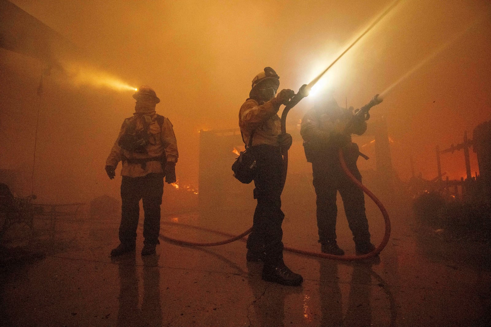 Fire crews battle the Eaton Fire Wednesday, Jan. 8, 2025 in Altadena, Calif. (AP Photo/Ethan Swope)