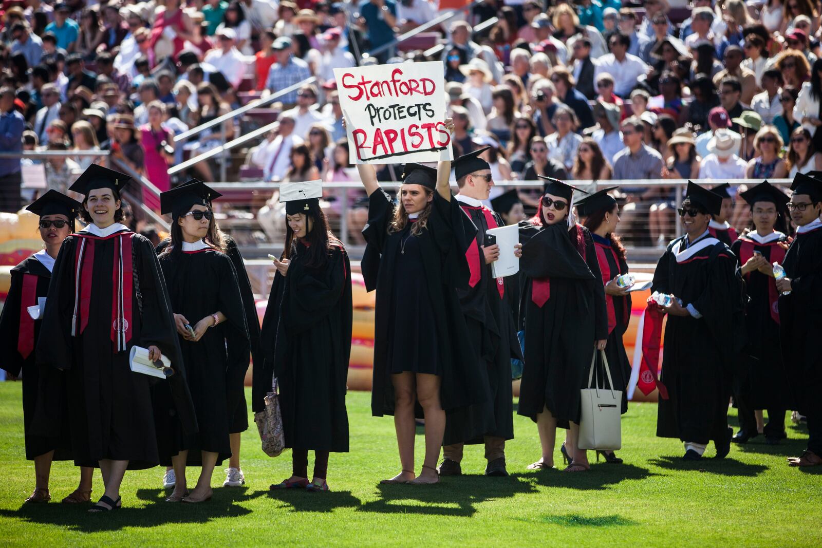 STANFORD, CA - JUNE 12: Graduating student, Andrea Lorei, who help organize campus demonstrations holds a sign in protest during the 'Wacky Walk' before the 125th Stanford University commencement ceremony on June 12, 2016 in Stanford, California. The university holds its commencement ceremony amid an on-campus rape case and its controversial sentencing. (Photo by Ramin Talaie/Getty Images)