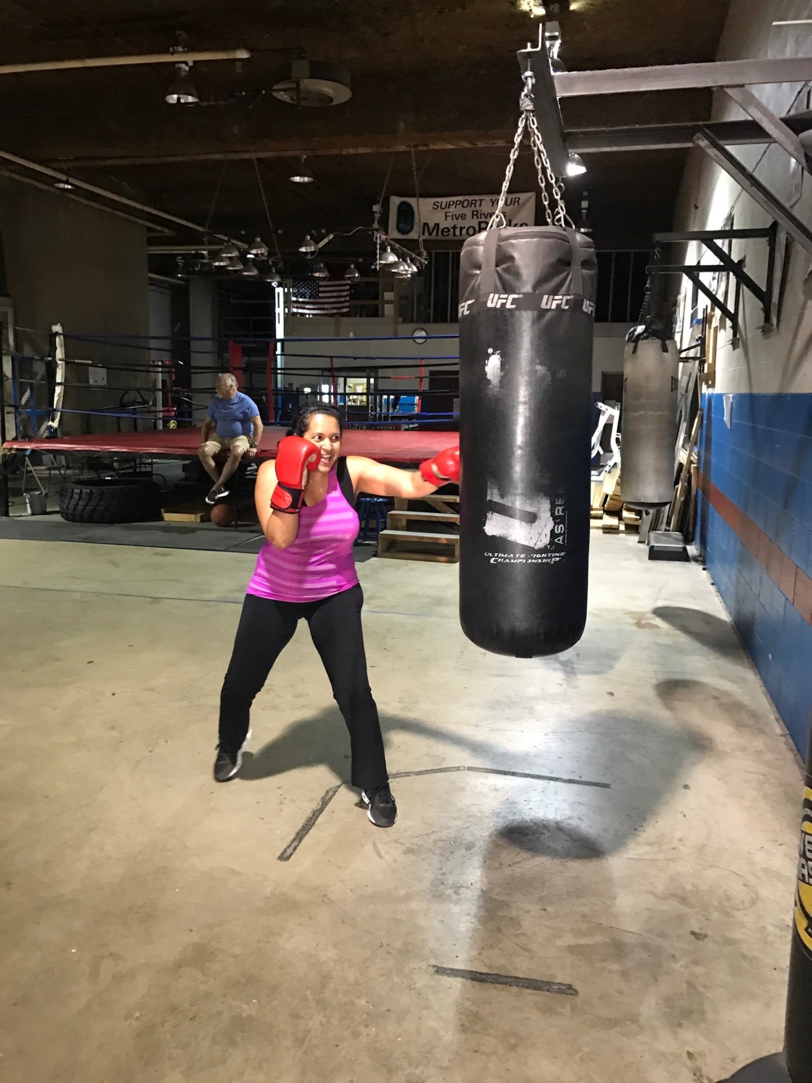 Dr. Luxme Hariharan – who does boxing workouts 2 to 3 days a week at Drake’s Downtown Gym before heading to Dayton Children’s Hospital where she is the new Chief of Ophthalmology and Chief Population Health Officer – hits the heavy bag as club owner John Drake oversees from the ring apron. CONTRIBUTED