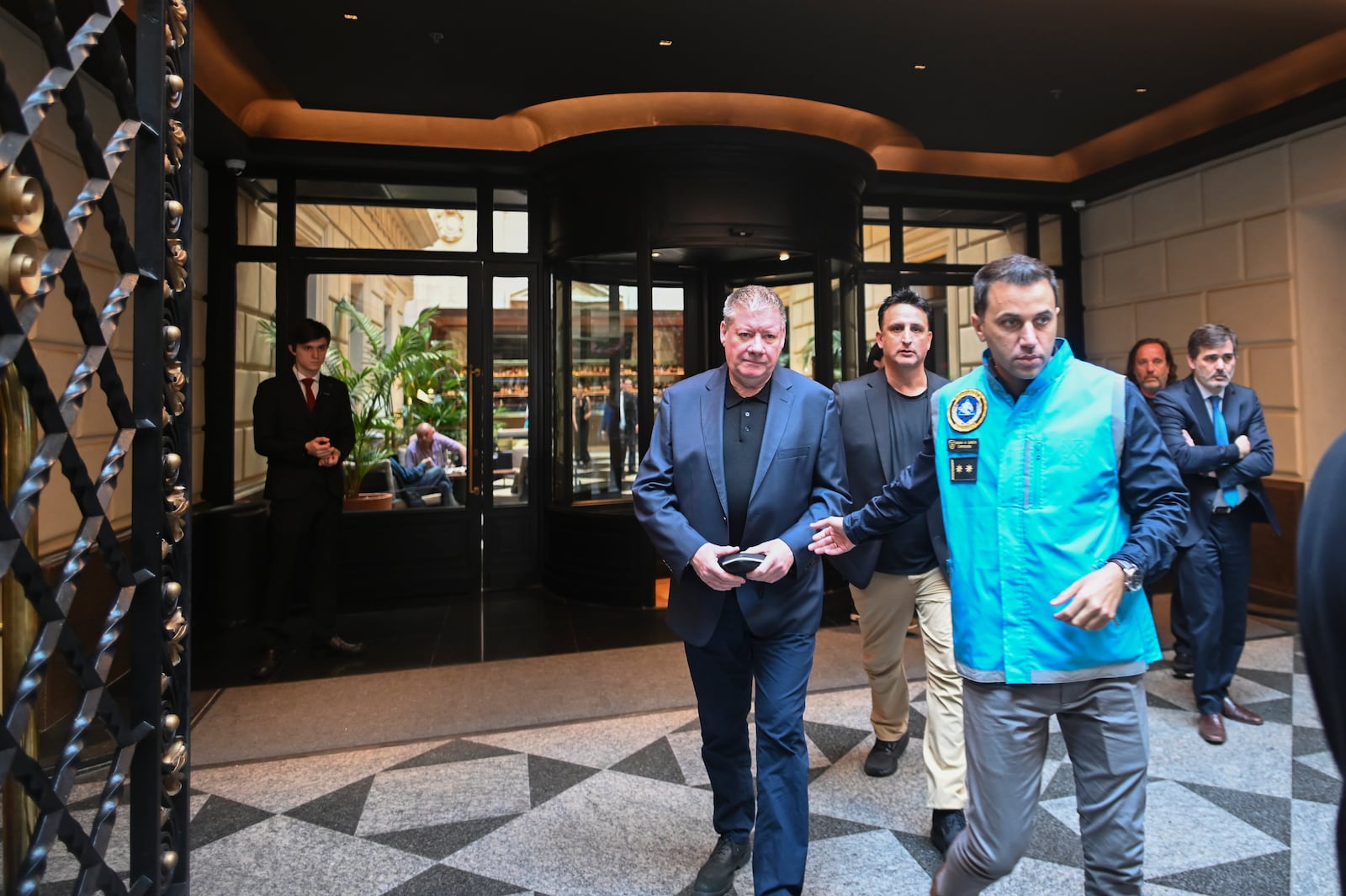 Geoff Payne, the father of the late ex-One Direction singer Liam Payne, center, leaves his hotel in Buenos Aires, Argentina, two days after his son died, Friday, Oct. 18, 2024. (AP Photo/Mario De Fina)