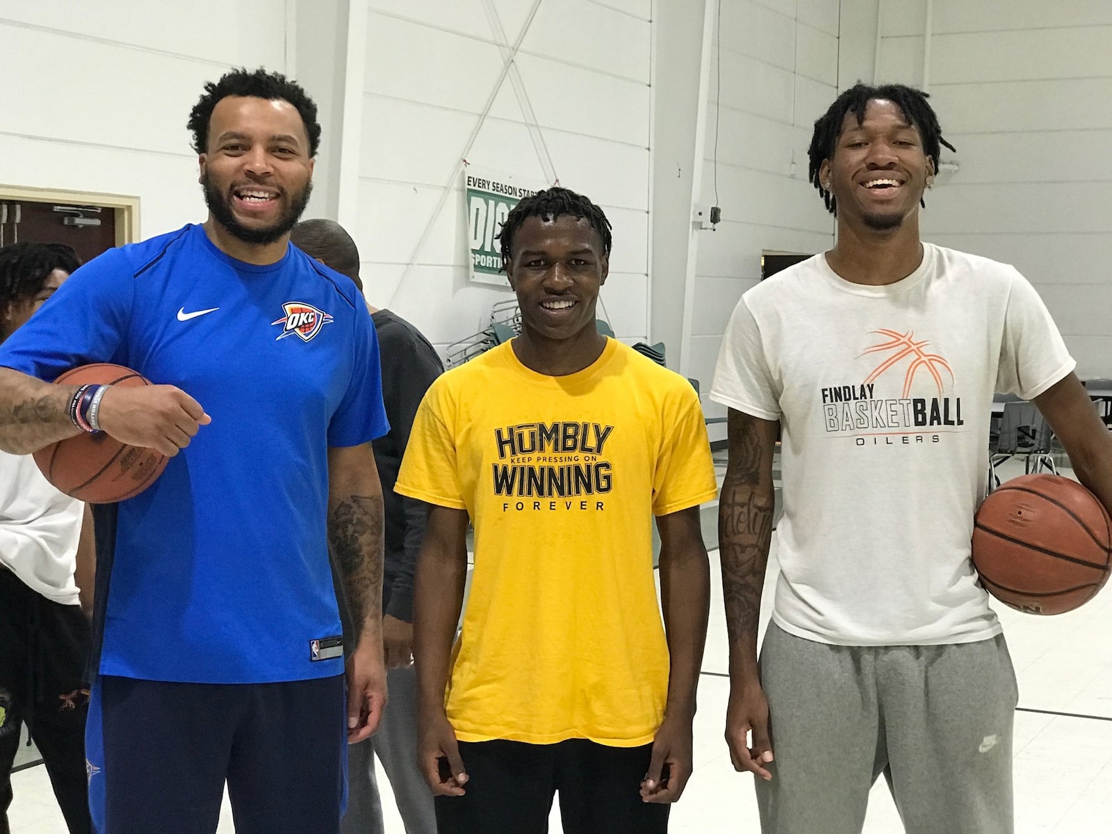 Three local basketball standouts take a break at in the Corinthian Baptist Church gym Thursday afternoon. From left: Daequan Cook, the former NBA player, longtime overseas pro and McDonald’s All American star of his Dunbar High state championships team,  with recently graduated Meadowdale High players, point guard Kalerrio Reaves , who is headed to Clark State, and 6-foot-8 Lee Benson III, who plans to play a season at a prep school before college basketball. Tom Archdeacon/CONTRIBUTED