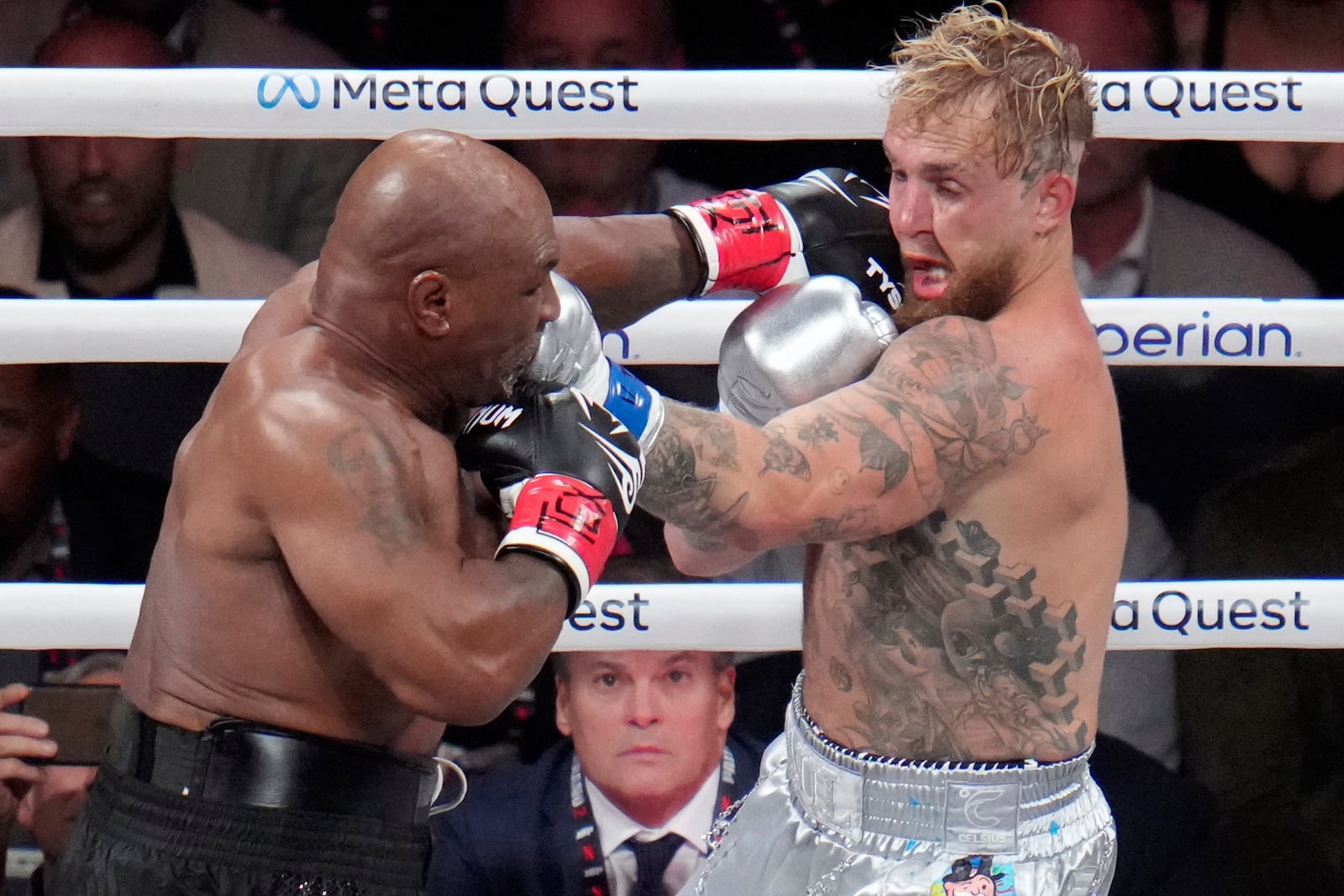 Mike Tyson hits Jake Paul during their heavyweight boxing match, Friday, Nov. 15, 2024, in Arlington, Texas. (AP Photo/Julio Cortez)