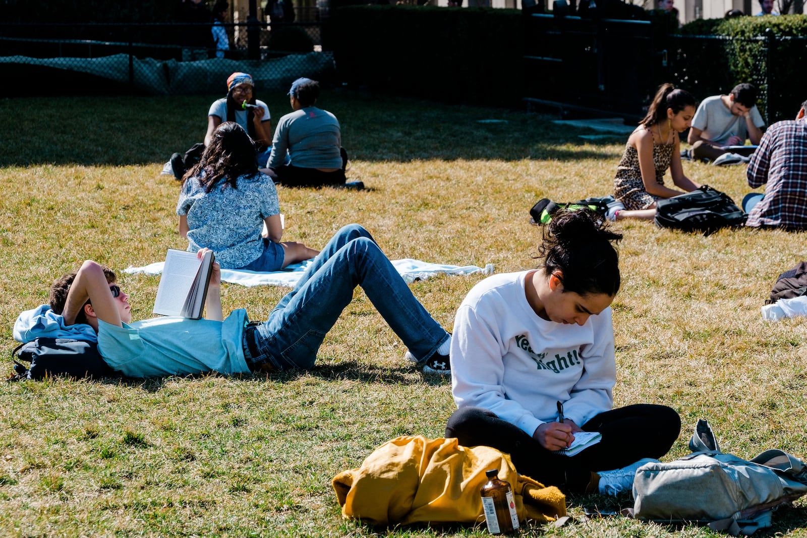 FILE - People read on the quad at Columbia University's campus in New York, March 9, 2020.  The growth of Parent PLUS borrowing means that the student debt crisis facing the young is moving backward in time to snare their parents. (Gabriela Bhaskar/The New York Times)