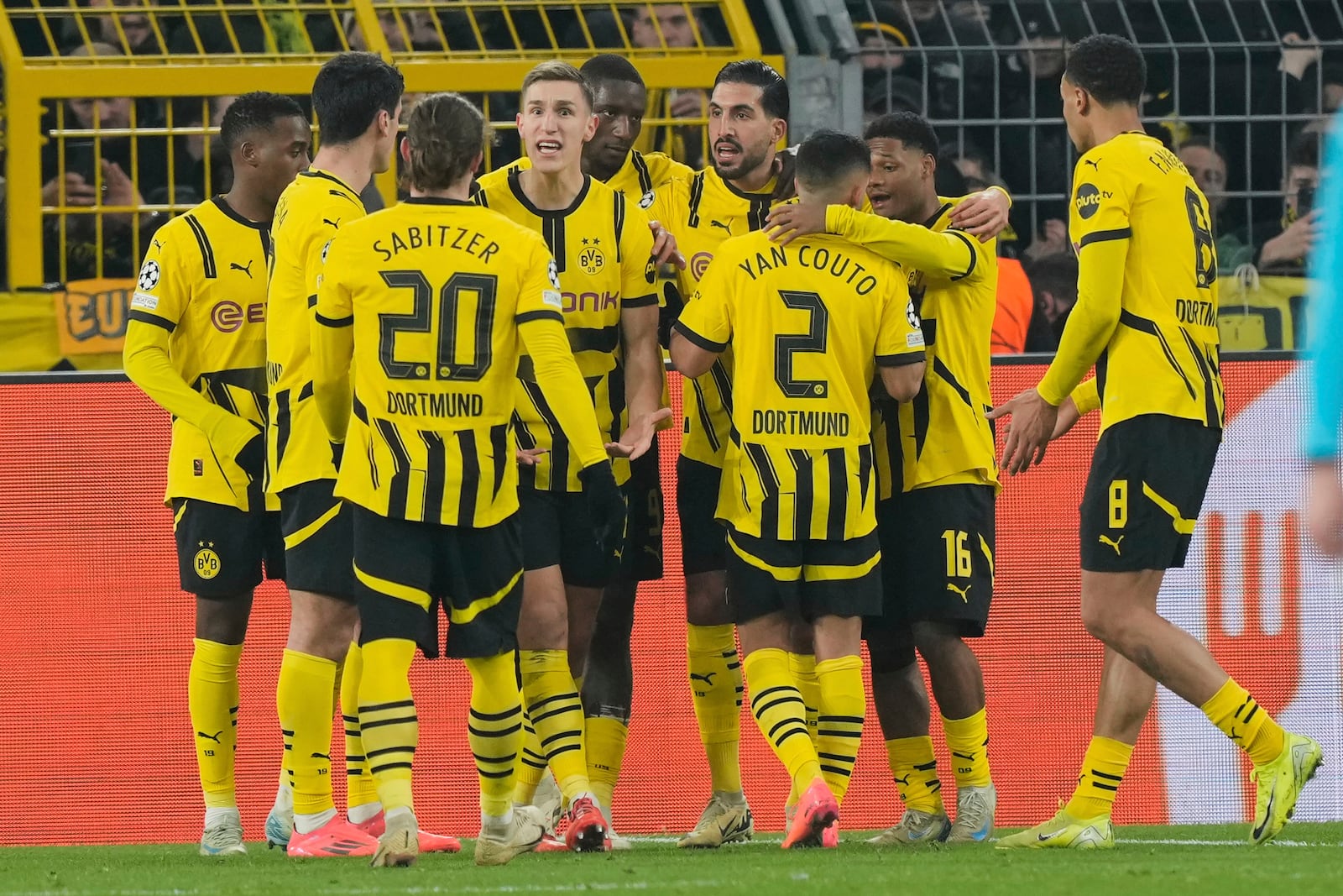 Dortmund's Serhou Guirassy celebrates with team mates his side's first goal during the Champions League opening phase soccer match between Borussia Dortmund and FC Barcelona at the Signal-Iduna Park in Dortmund, Germany, Wednesday Dec. 11, 2024. (AP Photo/Martin Meissner)