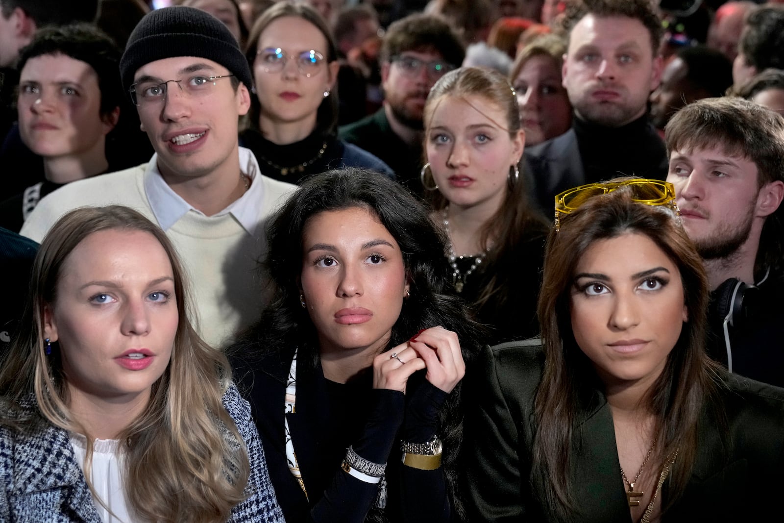 People react after first projections are announced during the election party at the Social Democratic Party (SPD) headquarters in Berlin, Germany, Sunday, March 23, 2025. (AP Photo/Ebrahim Noroozi)