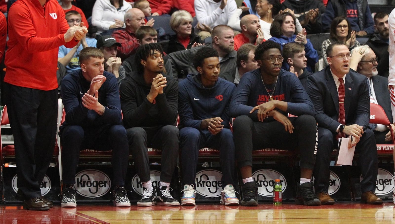 Dayton players (left to right) Chase Johnson, Ibi Watson, Rodney Chatman and Jordy Tshimanga sit on the bench, along with coach Andy Farrell, far right, against Massachusetts on Sunday, Jan. 13, 2019, at UD Arena. David Jablonski/Staff