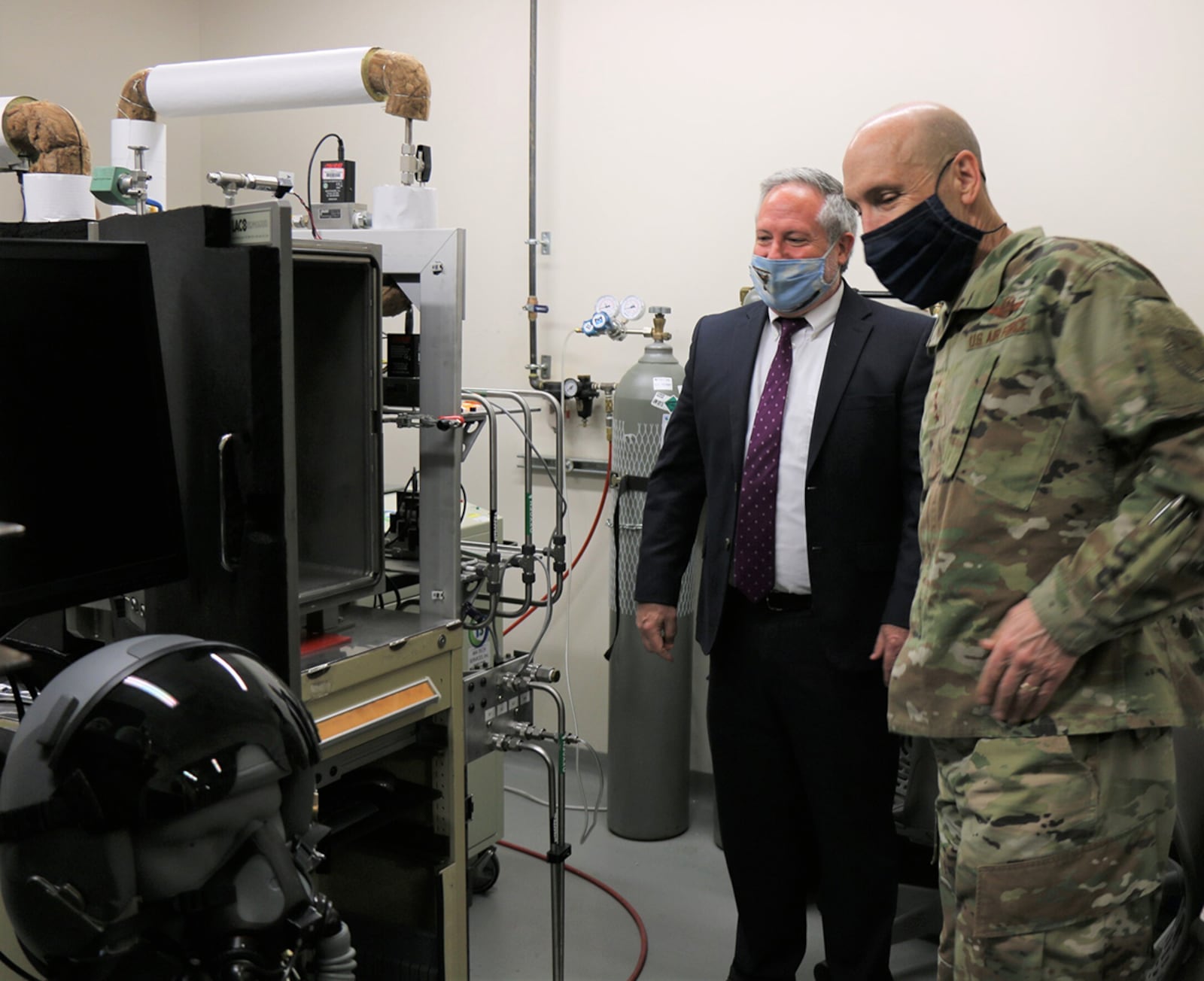 Dr. Richard Arnold, director, Naval Aerospace Medical Research Laboratory, NAMRU-Dayton speaks to Gen. David Allvin, Air Force vice chief of staff, April 26. Allvin was briefed on the Navy-Air Force joint capability in aerospace physiology research at WPAFB. They are standing in the NAMRU-Dayton sensors laboratory, one of several laboratories conducting operationally relevant research for warfighter health, safety and performance. U.S. NAVY PHOTO/MEGAN MUDERSBACH