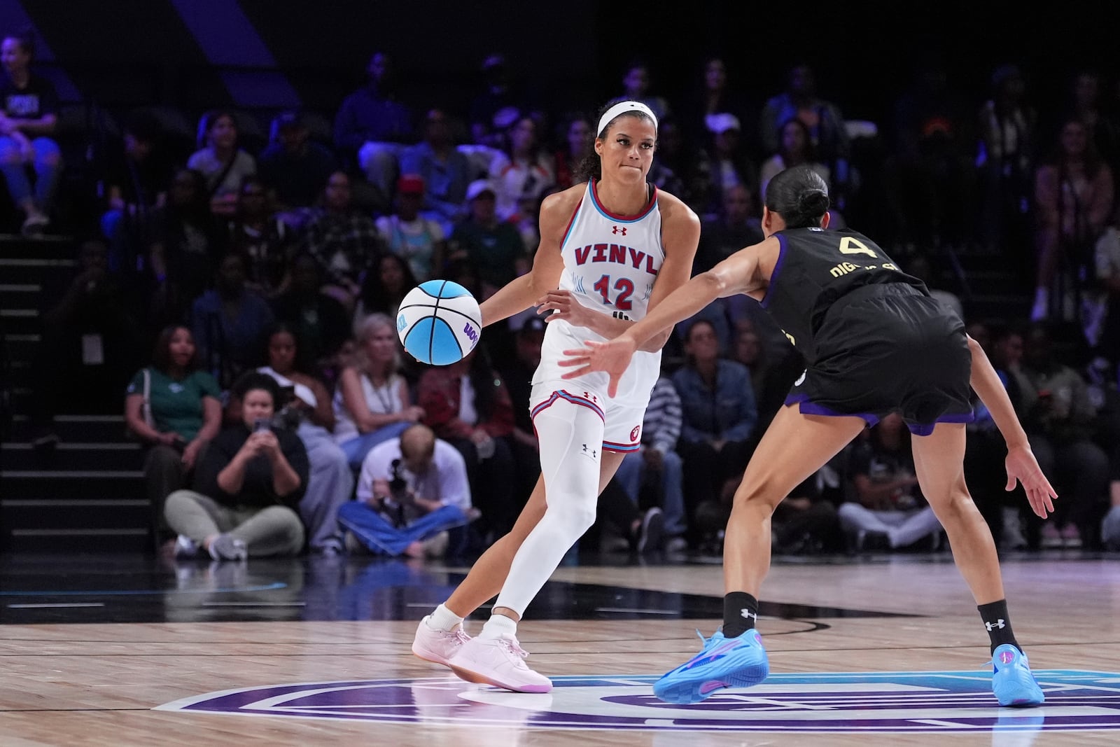 Vinyl wing Rae Burrell dribbles defended by Lunar Owls guard Skylar Diggins-Smith in their Unrivaled 3-on-3 basketball semifinal, Sunday, March 16, 2025, in Medley, Fla. (AP Photo/Rebecca Blackwell)