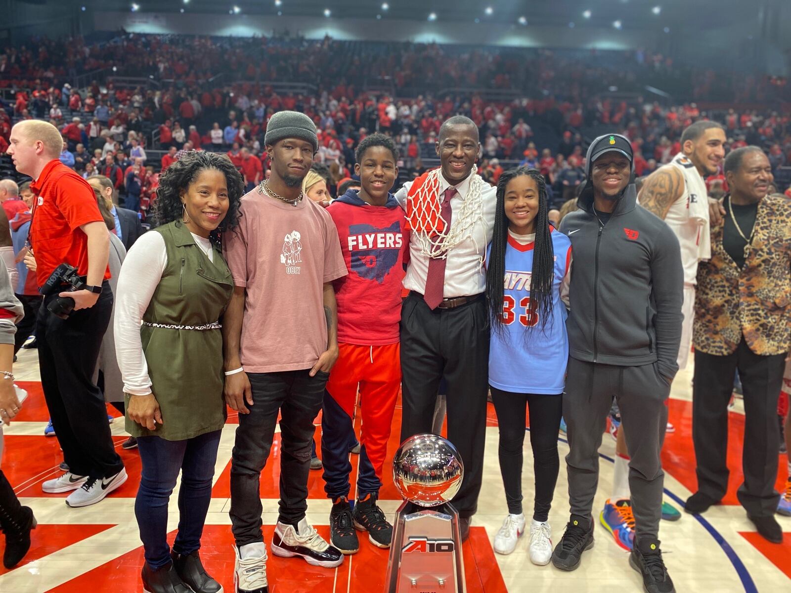 The Grant Family celebrated the No. 3 Dayton Flyers finishing the 2019-20  regular season with a 76-51 Senior Night victory over George Washington on March 7, 2020. With the win, the 29-2 Flyers finished the regular season unbeaten in the Atlantic 10 and at UD Arena. (Pictured left to right): Chris, A.J. Makai, Anthony – who would be named the National College Coach of the Year – Jayda  and Preston. In the back on the right is UD’s Obi Toppin ,the national collegiate player of the year, and former Flyer, the Rev. J.D Grigsby. CONTRIBUTED