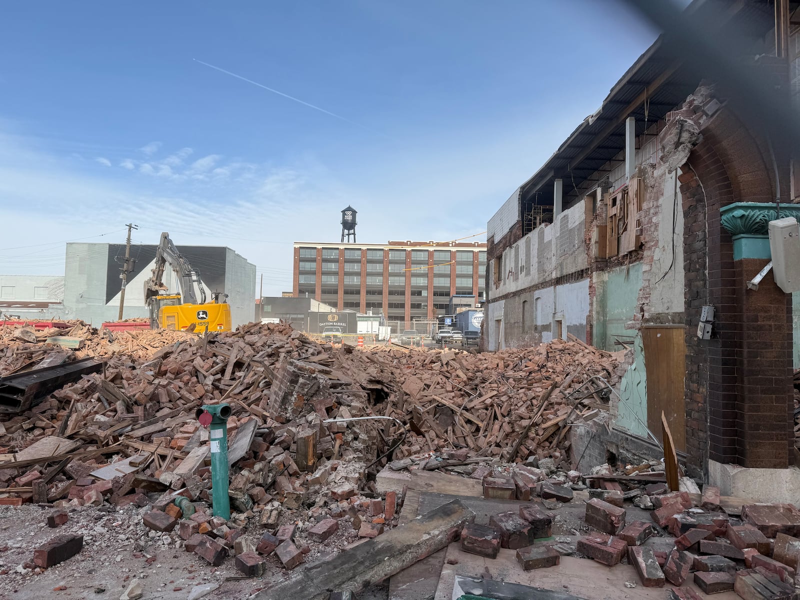 Two buildings on the 400 block of East Third Street in downtown Dayton that once belonged to KK Motorcycle Supply have been torn down. Site plans indicate the properties will become a new parking lot. A building on the same block is supposed to become new offices. CORNELIUS FROLIK / STAFF