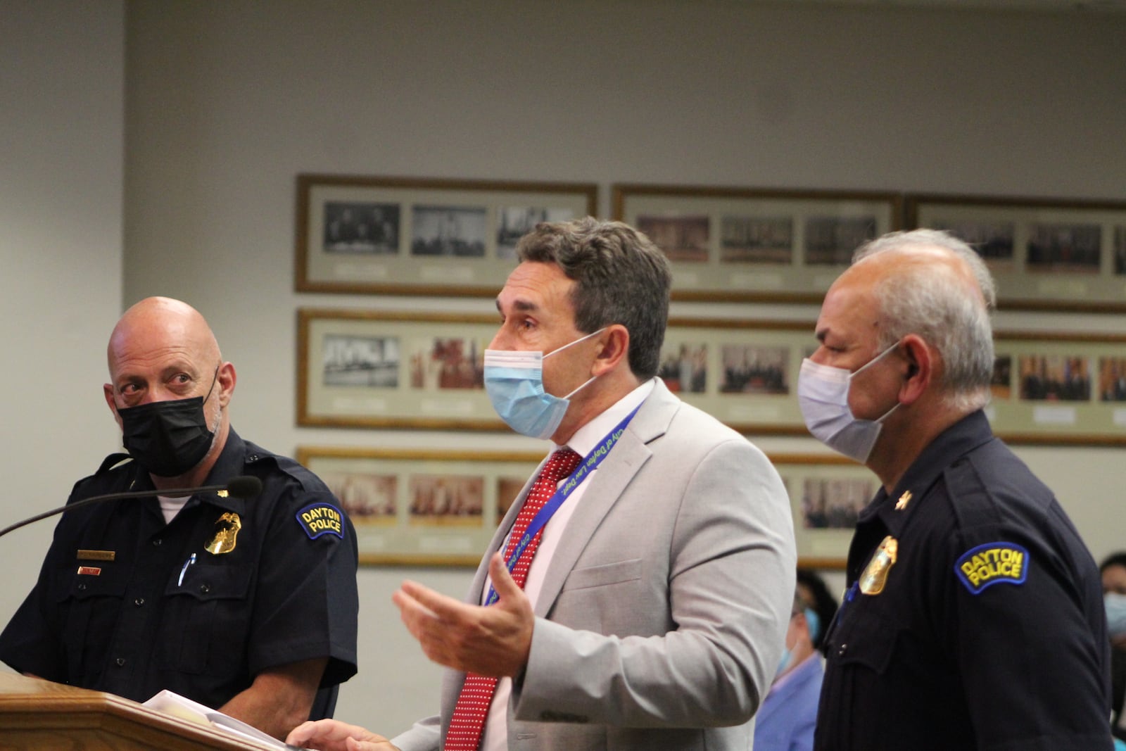 Dayton police Chief Kamran Afzal, Major Paul Saunders and John Musto with the law department at Wednesday's city commission meeting. Visitors were required to wear masks. CORNELIUS FROLIK / STAFF