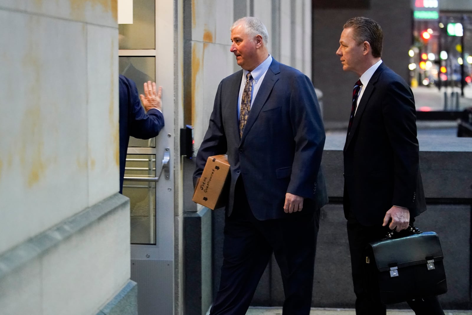 Former Ohio House Speaker Larry Householder, center, walks into Potter Stewart U.S. Courthouse with his attorneys, Mark Marein, left, and Steven Bradley, right, before jury selection in his federal trial, Friday, Jan. 20, 2023, in Cincinnati. Householder and former Ohio Republican Party chair Matt Borges are charged with racketeering in an alleged $60 million scheme to pass state legislation to secure a $1 billion bailout for two nuclear power plants owned by Akron, Ohio-based FirstEnergy. Householder and Borges have both pleaded not guilty. (AP Photo/Joshua A. Bickel)