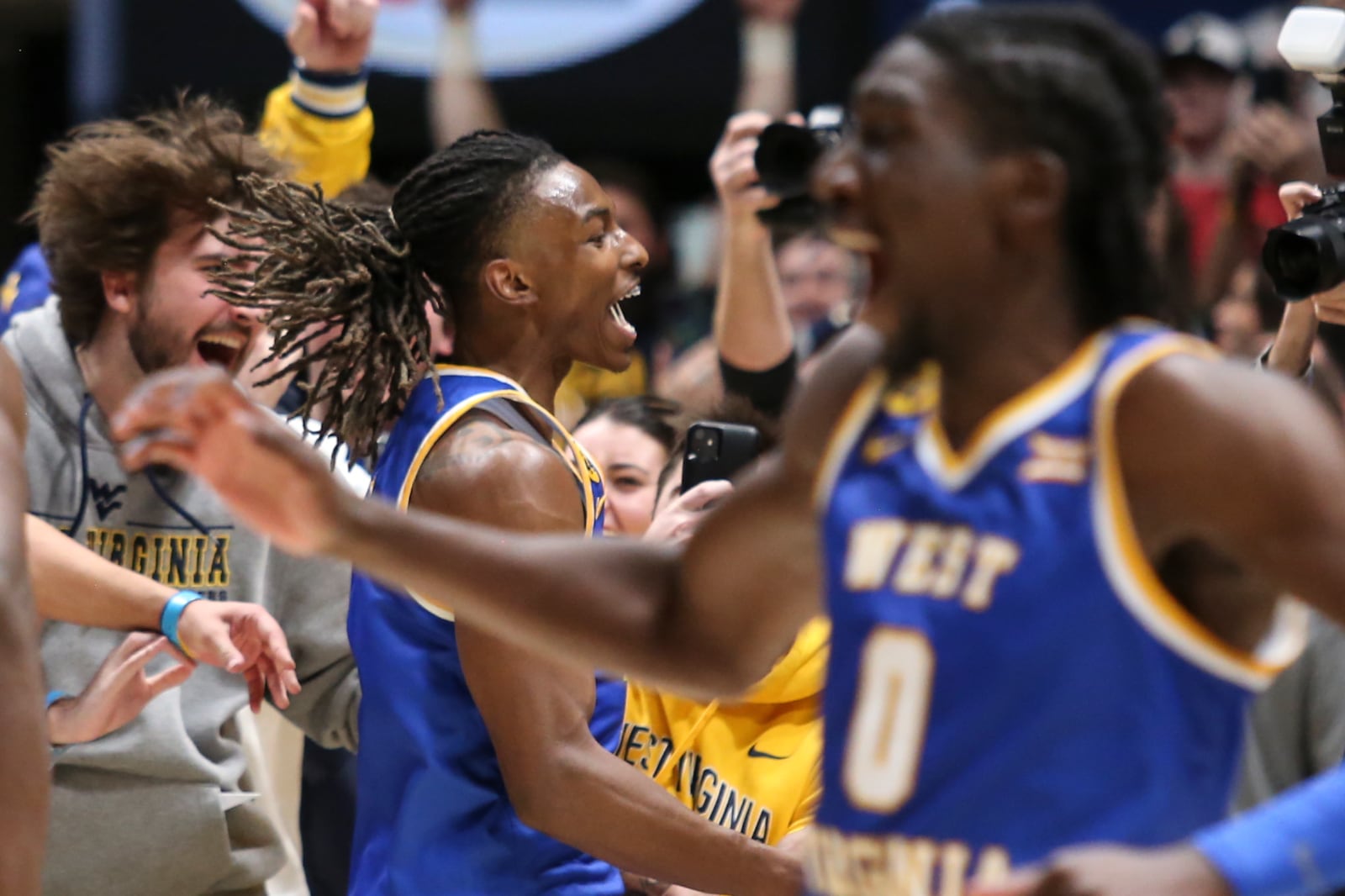 West Virginia guard Javon Small (7) celebrates with the students after defeating Iowa State in a NCAA college basketball game, Saturday, Jan. 18, 2025, in Morgantown, W.Va. (AP Photo/William Wotring)