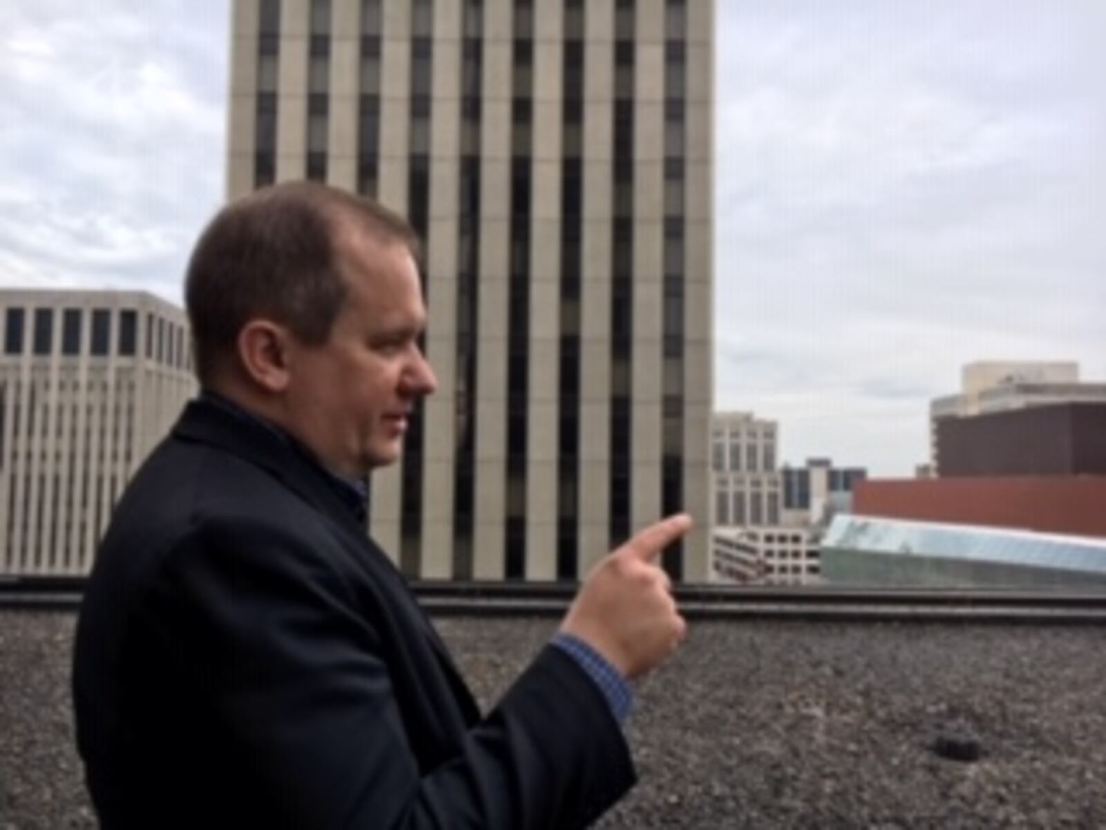 Chris Riegel, chief executive of Dayton digital tech firm Stratacache, talks on a lower roof of Stratacache Tower. THOMAS GNAU/STAFF