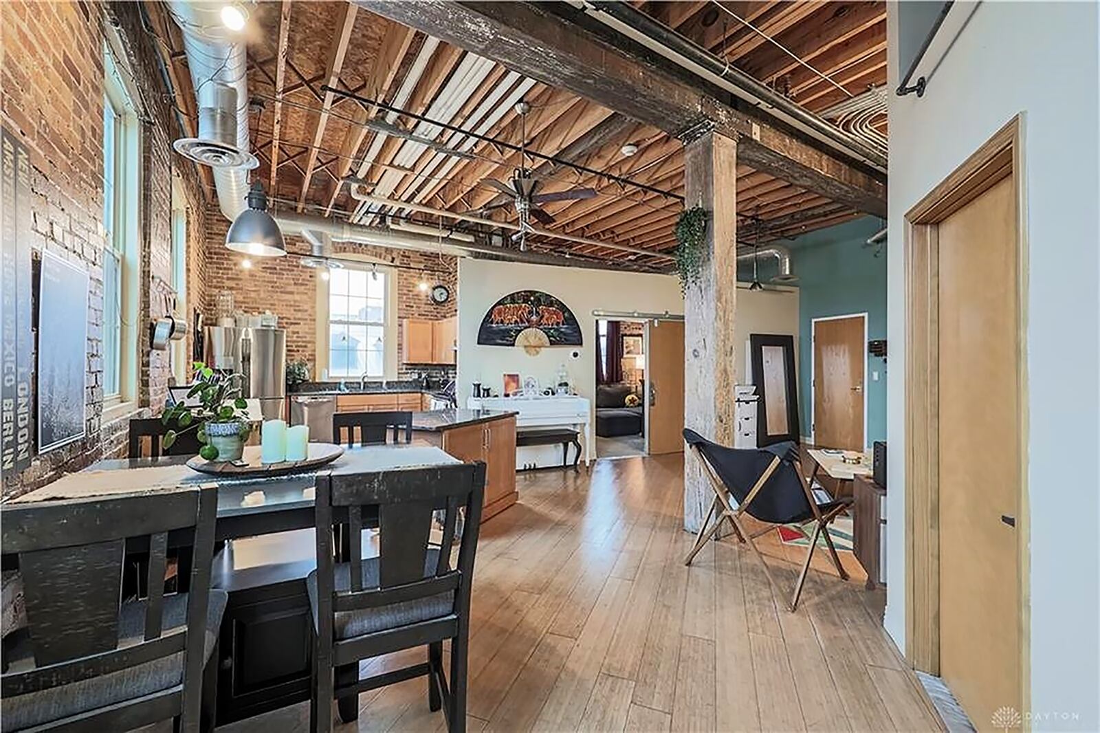 The front door opens into a great room with a repurposed industrial design with exposed floor-joist ceiling, exposed brick exterior walls and chrome ventilation tubes and ducts. Refinished wood flooring flows throughout the main social areas accept the kitchen and bathrooms, which have a tough-grade vinyl. CONTRIBUTED PHOTO