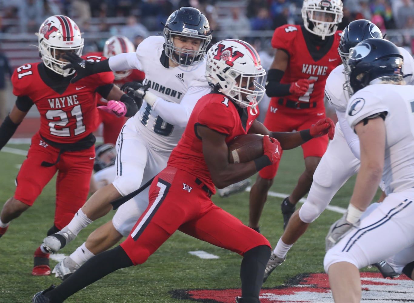 Wayne’s RJ Mukes carries the ball against Fairmont during Friday’s game. BILL LACKEY/STAFF