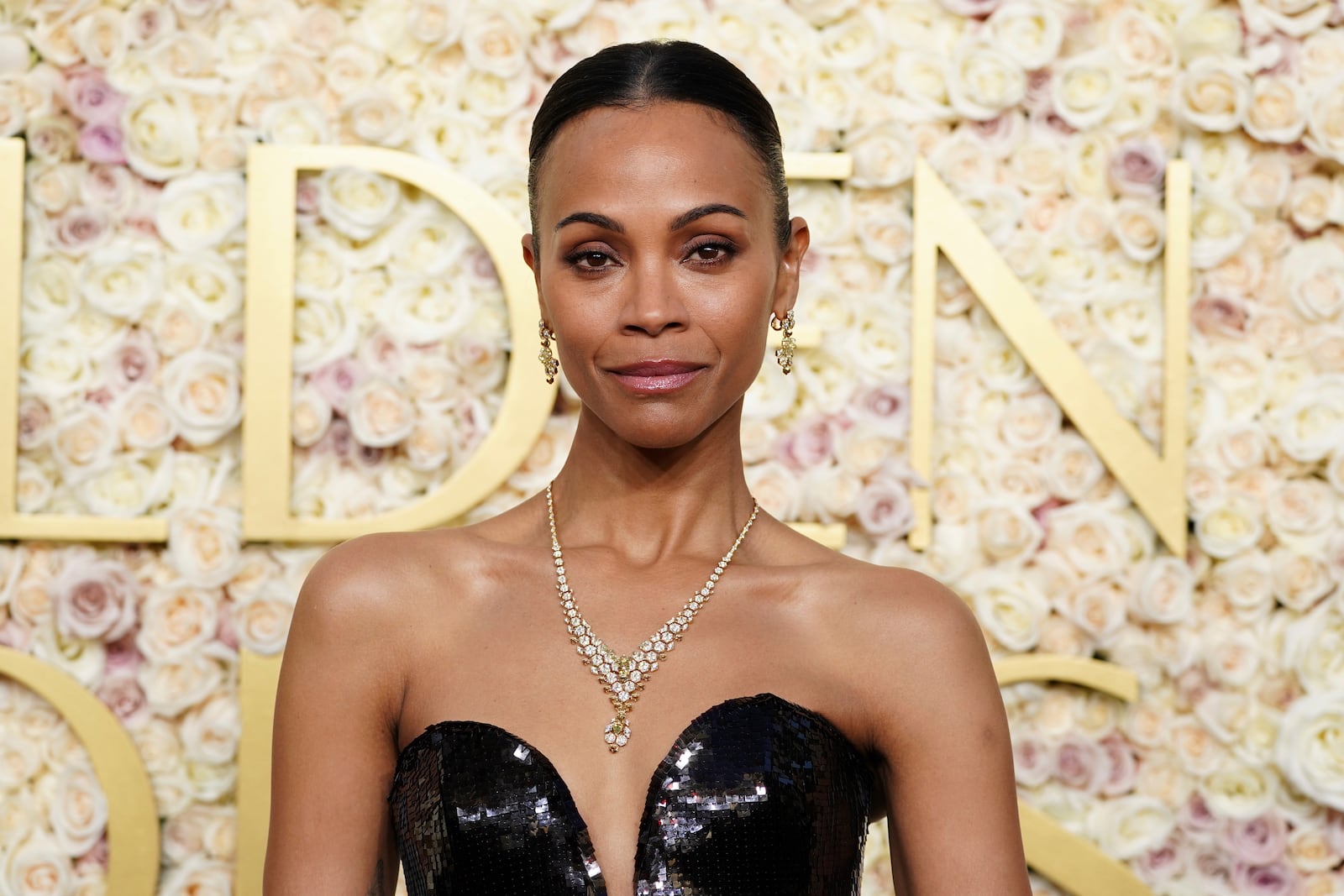 Zoe Saldana arrives at the 82nd Golden Globes on Sunday, Jan. 5, 2025, at the Beverly Hilton in Beverly Hills, Calif. (Photo by Jordan Strauss/Invision/AP)