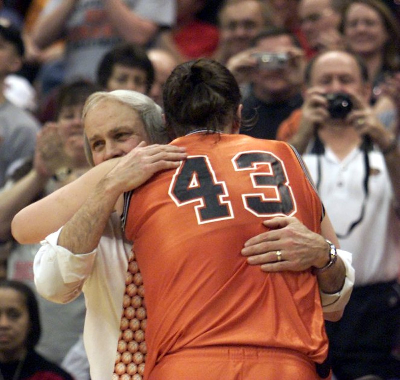 3-15-03 — Beavercreek’s Alison Bales hugs head coach Ed Zink as she leaves the game near the end of the Division I State Title game against Hudson in Columbus.. Beavercreek won 58-21. DDN file.