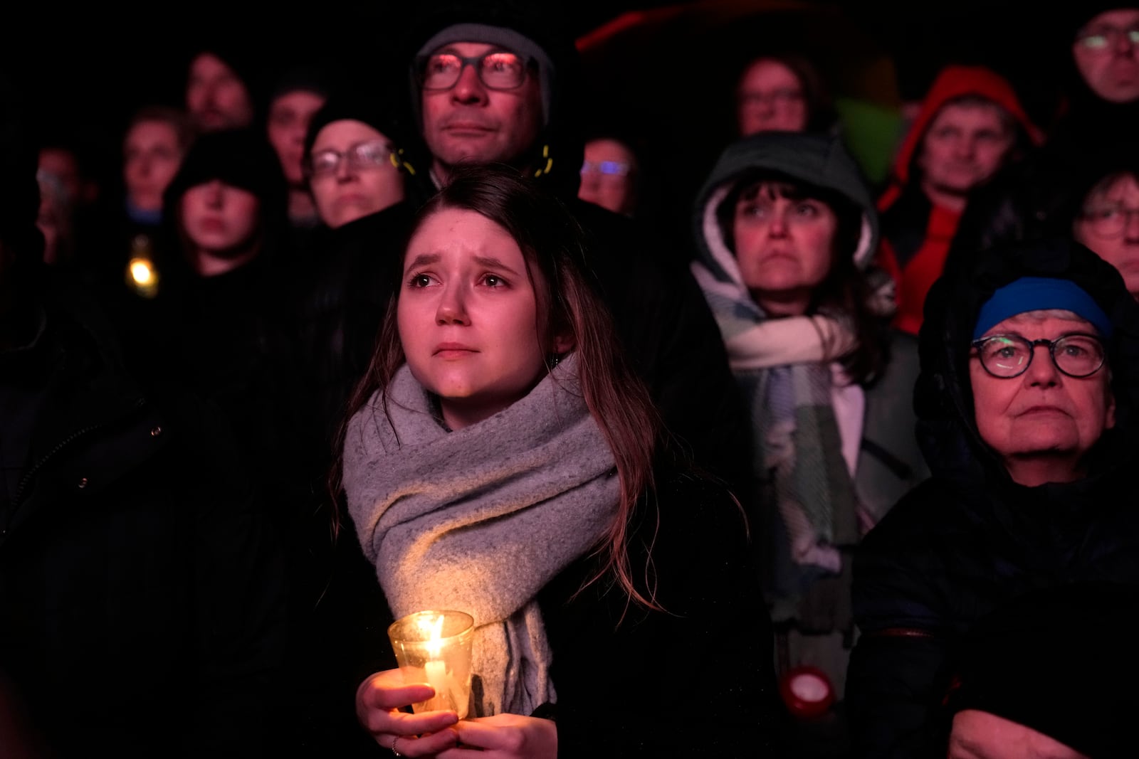 People outside Magdeburg Cathedral follow a memorial service for victims of Friday's Christmas Market attack, where a car drove into a crowd, in Magdeburg, Germany, Saturday, Dec. 21, 2024. (AP Photo/Ebrahim Noroozi)