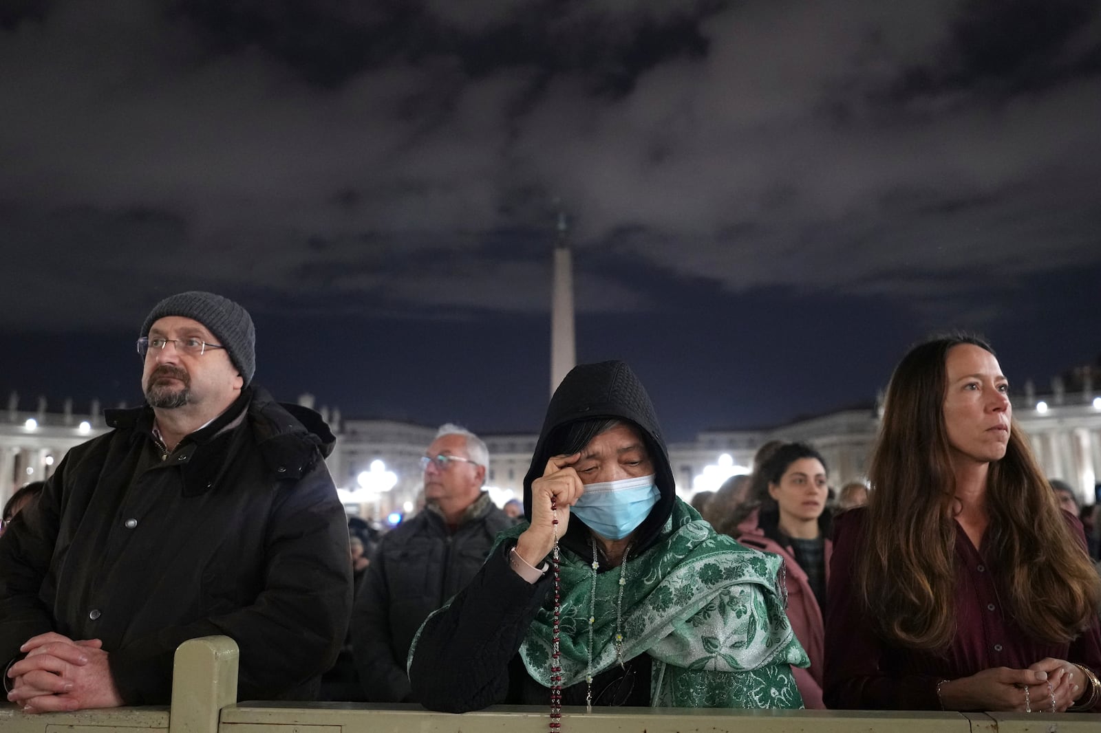 People attend a rosary prayer with Cardinal Victor Manuel Fernandez held for the health of Pope Francis in St Peter's Square at The Vatican, Friday, Feb. 28, 2025. (AP Photo/Kirsty Wigglesworth)