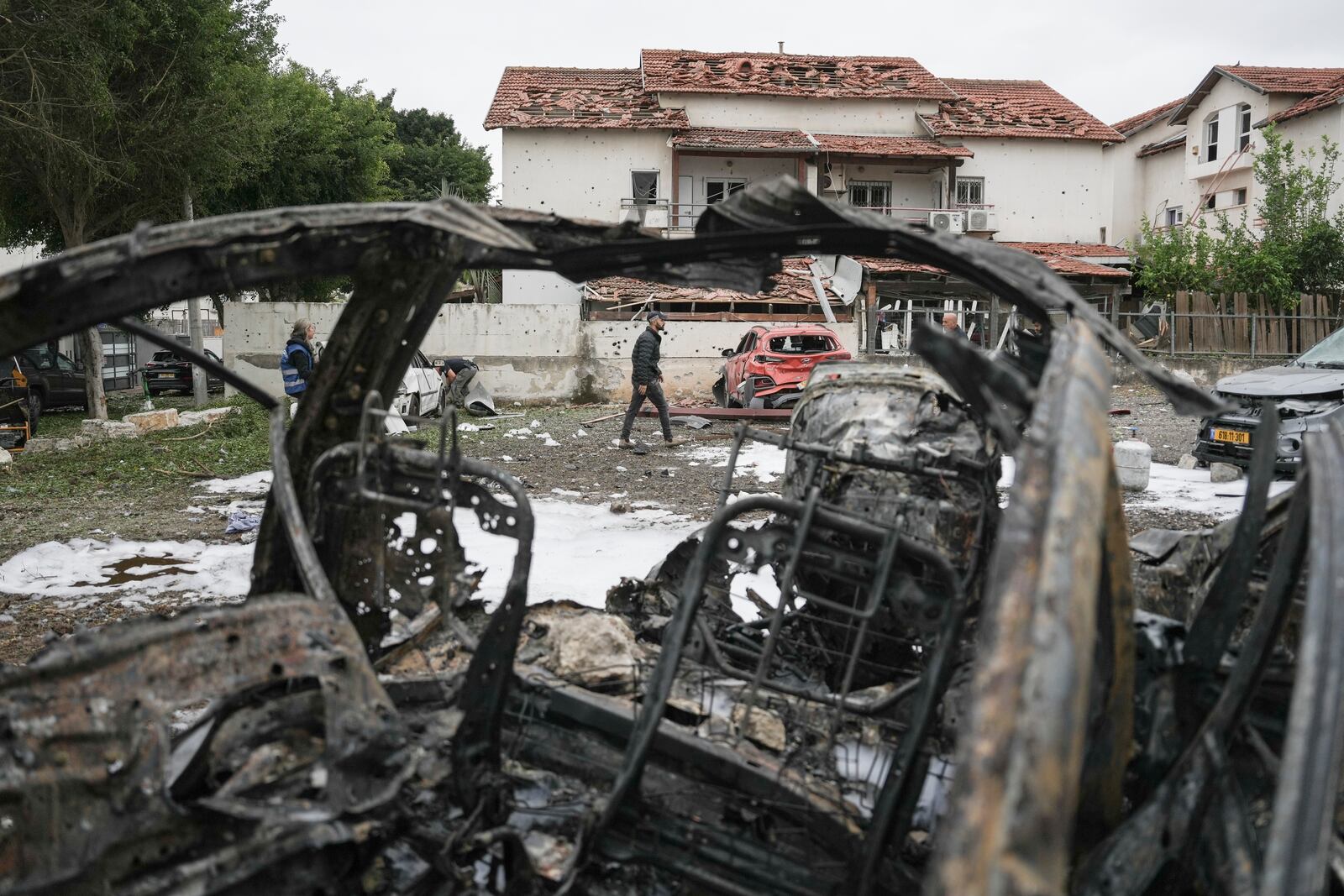 Israeli police bomb squad inspect the site after a missile fired from Lebanon hit the area in Petah Tikva, outskirts of Tel Aviv, Israel, Sunday Nov. 24, 2024. (AP Photo/Oded Balilty)