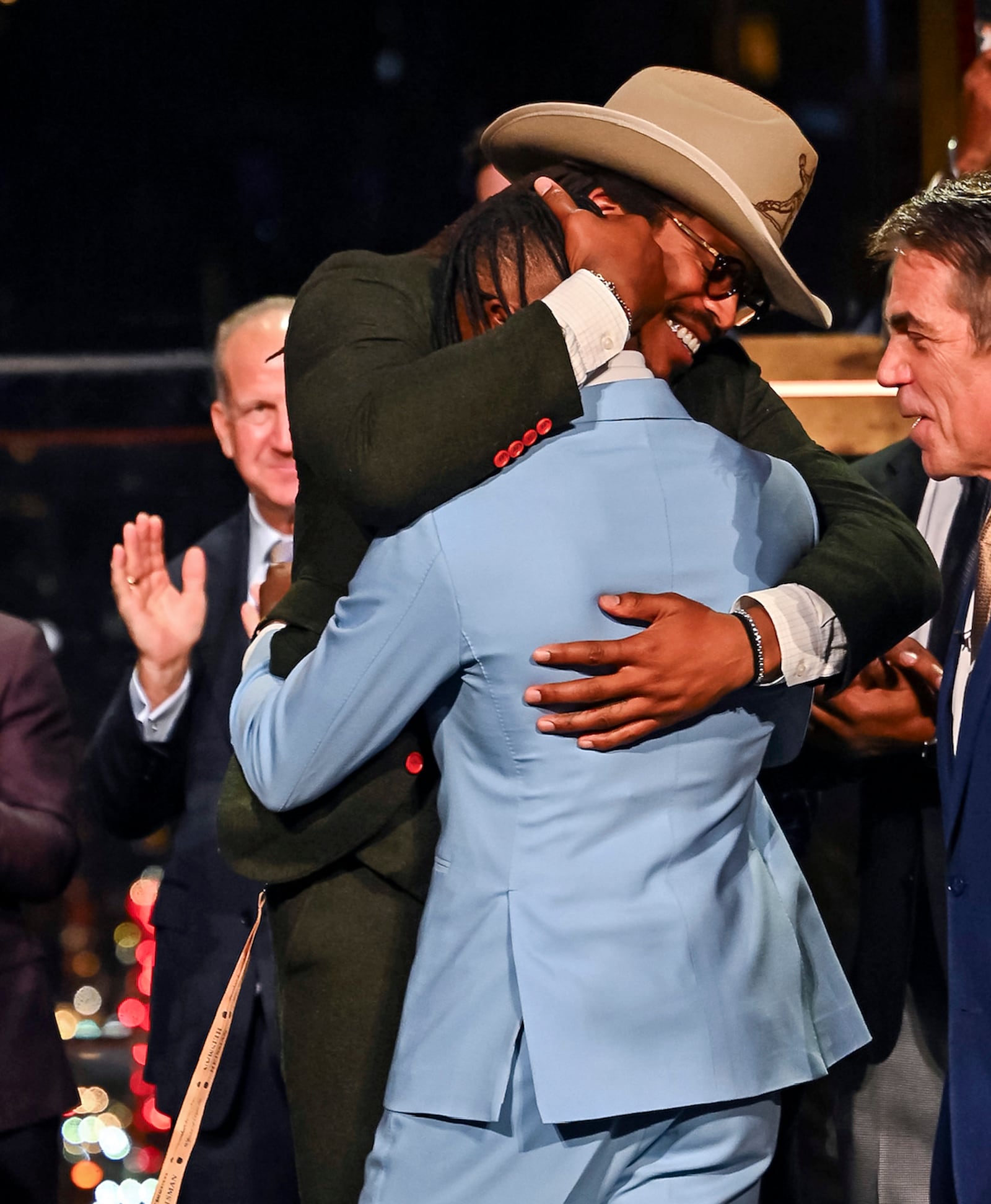 Colorado’s Travis Hunter, in blue, is embraced by 2010 Heisman winner Cam Newtown after winning the Heisman Trophy as the outstanding player in college football, Saturday, Dec. 14, 2024, in New York.(Todd Van Emst/Heisman Trust via AP, Pool)