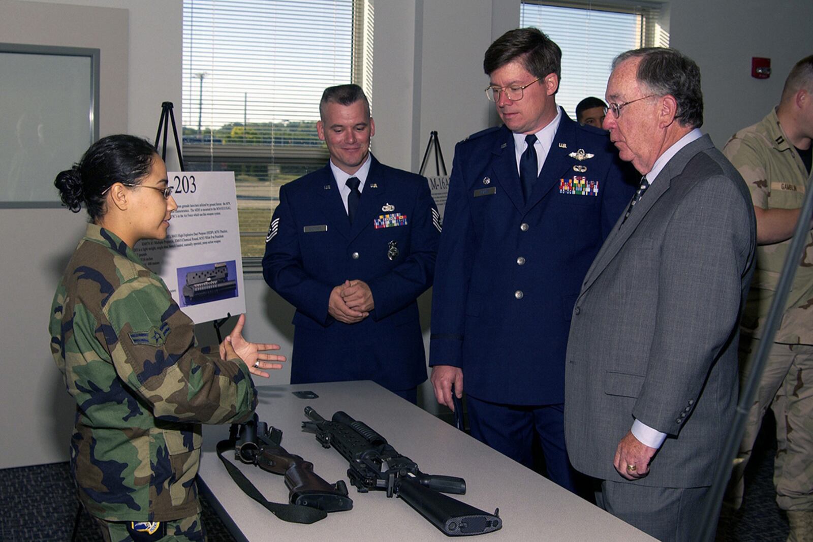 Airman 1st Class Monica Erazo briefs Rep. David Hobson, R-Ohio, and Col. Andrew Weaver (second from right), then-88th Air Base Wing commander, on the M79 grenade launcher and a 5.56 mm M16A1 with an attached M203 40 mm grenade launcher Sept. 20, 2004, at Wright-Patterson Air Force Base. U.S. AIR FORCE PHOTO/MELVIN BAUMGARDNER