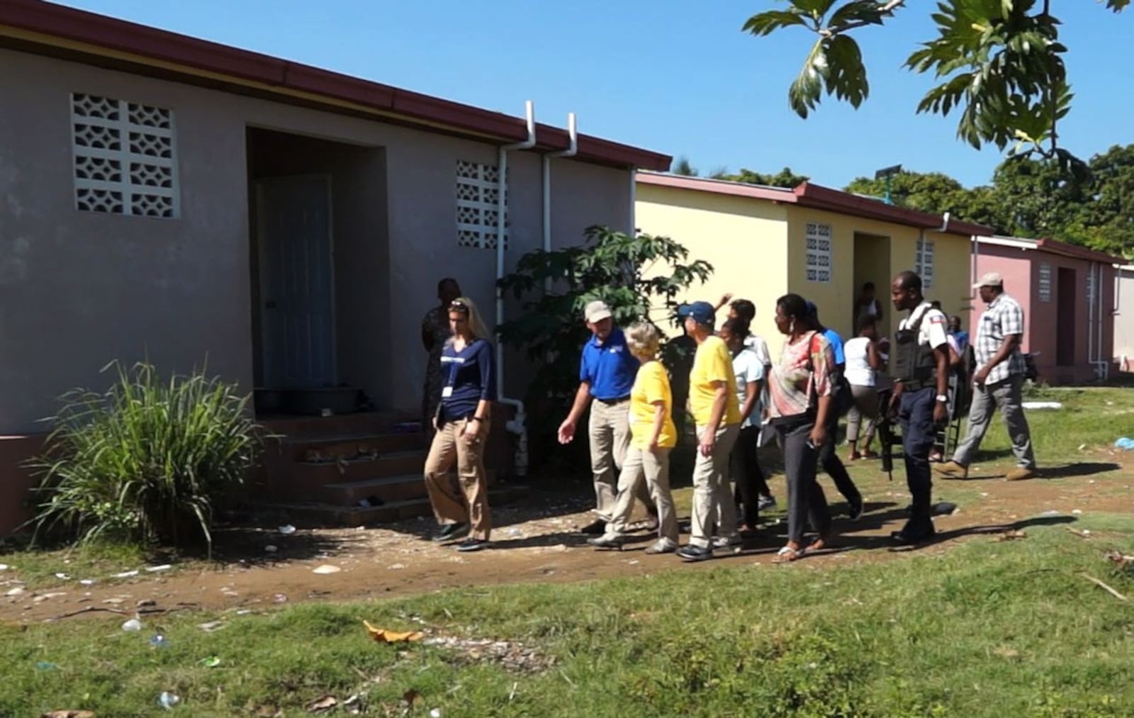 Several families in Alpha Village who received a home built by Boca Grande Hope For Haitians in Gressier, Haiti, last year welcomed back Co-Chairman Ben Scott, of Piqua, and first-time visitors Frank and Julie Gilardi, also of Piqua, during Scott's November mission trip. Boca Grande, through Food For The Poor, helped 130 families move out of the old Alpha Village, a community of rickety structures between the sea and an active landfill on the outskirts of Port-au-Prince, to the new location of secure concrete-block homes. (Photo/Food For The Poor)