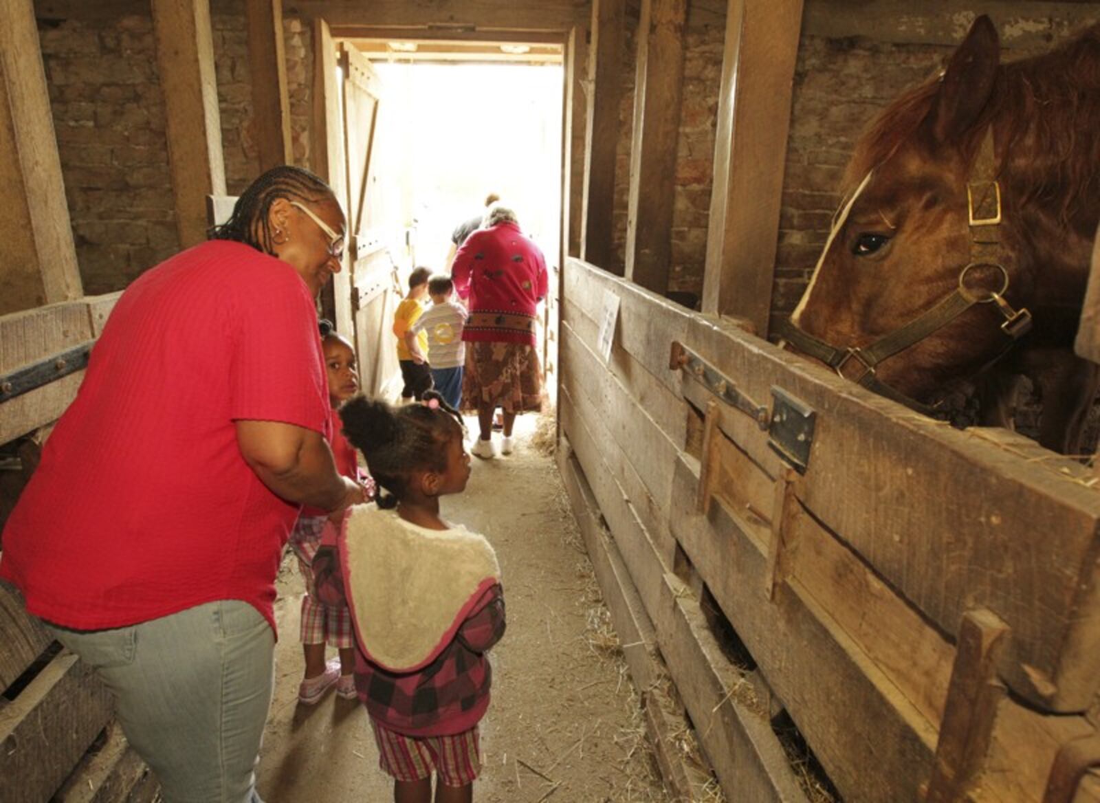 Preschool students tour the horse barn during a field trip at the Aullwood Farm.