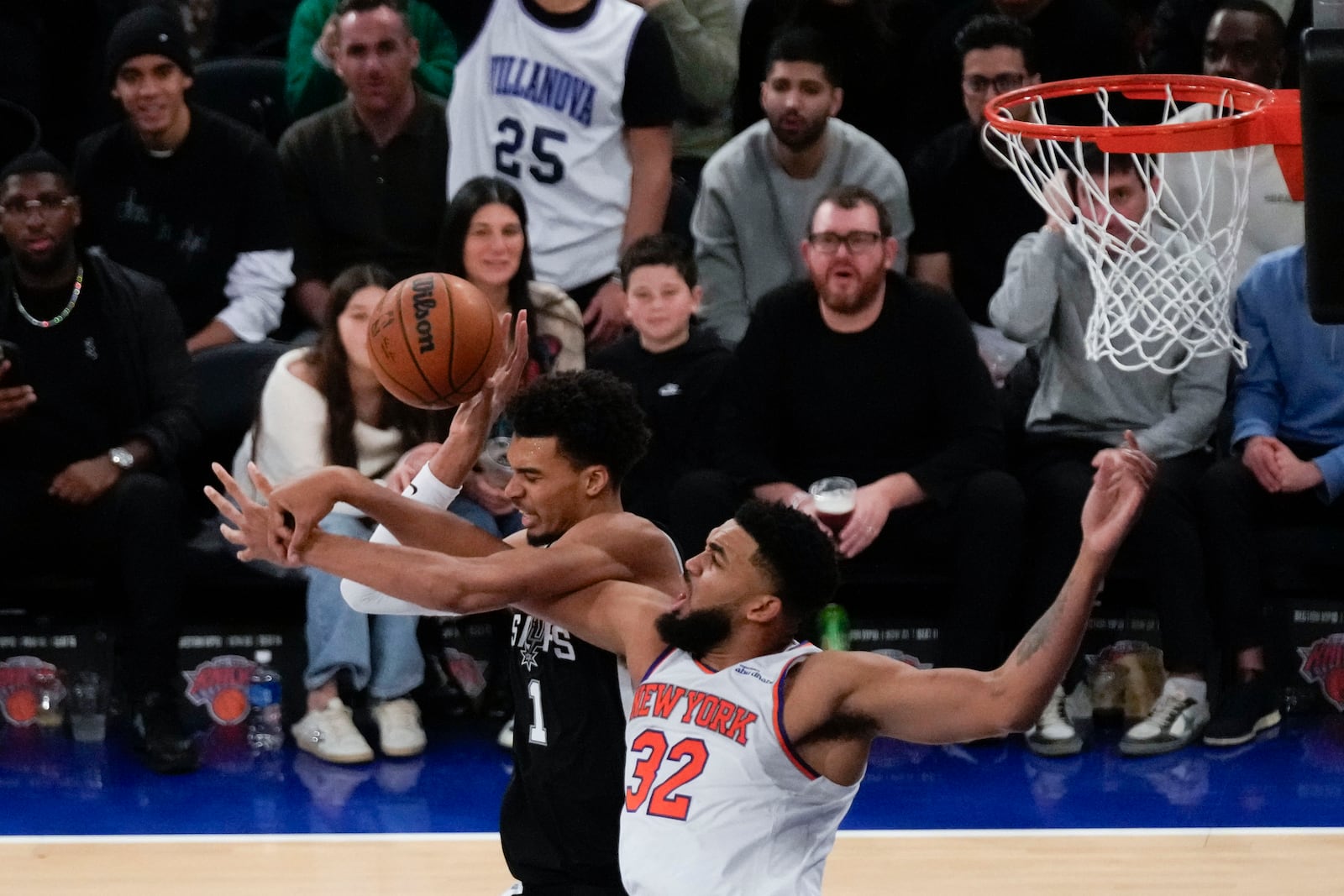 San Antonio Spurs' Victor Wembanyama, left, and New York Knicks' Karl-Anthony Towns fight for a rebound during the second half of an NBA basketball game, Wednesday, Dec. 25, 2024, in New York. The Knicks defeated the Spurs 117-114. (AP Photo/Seth Wenig)