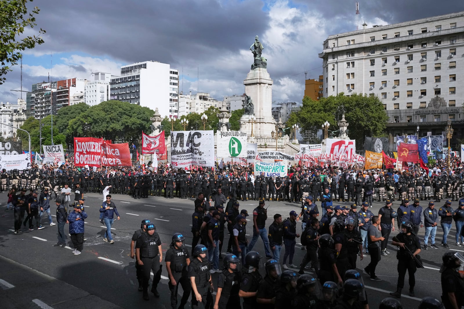 Soccer fans join retirees protesting for higher pensions and against austerity measures implemented by Javier Milei's government in Buenos Aires, Argentina, Wednesday, March 12, 2025. (AP Photo/Natacha Pisarenko)